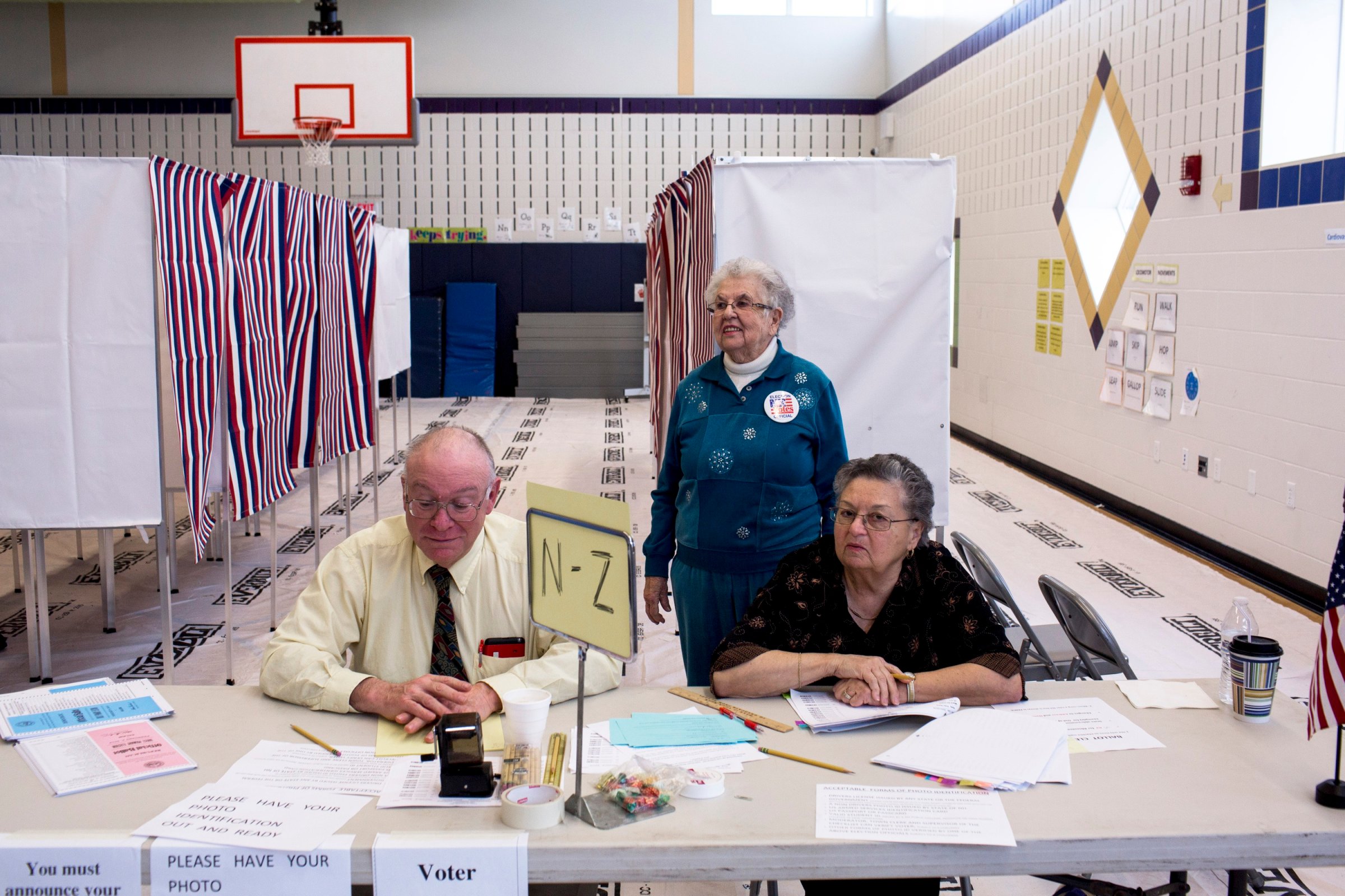 New Hampshire Volunteers staff a polling station at Windham High School on Feb. 9, 2016, in Windham, N.H.
