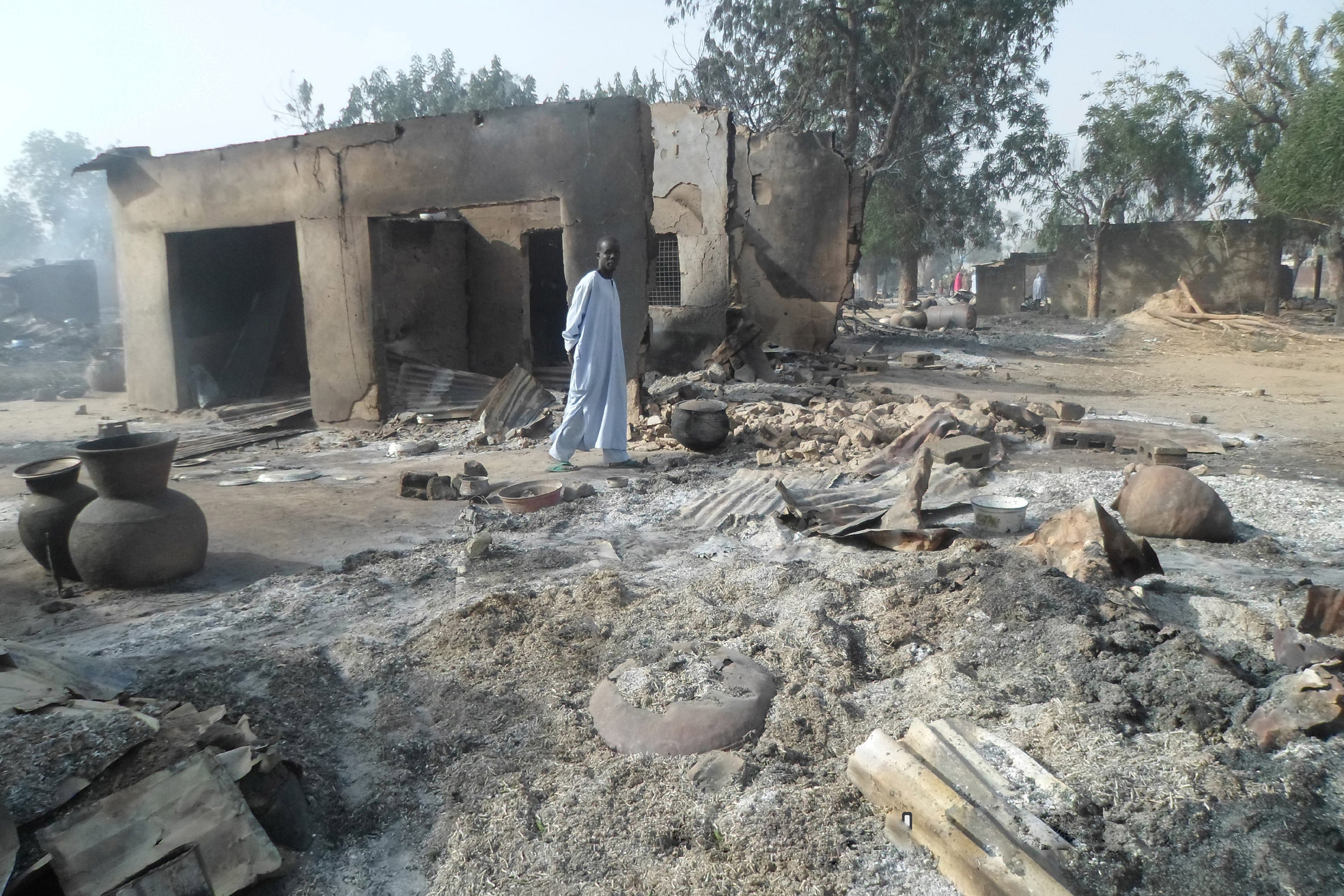 A man walks past burnt out houses following an attack by Boko Haram in the village of Dalori near Maiduguri, Nigeria, Jan. 31, 2016. (Jossy Ola—AP)