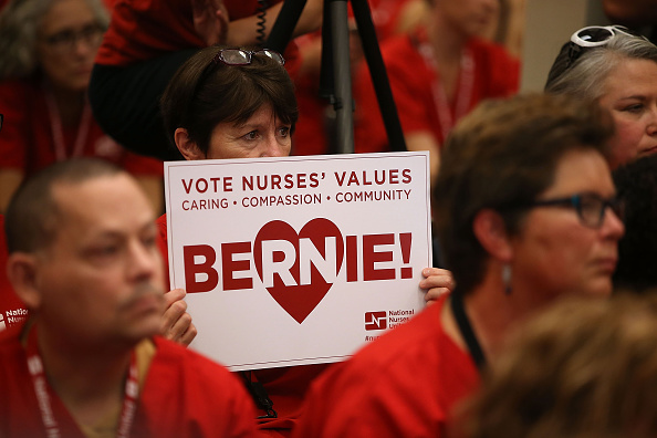 A nurse with the National Nurses United holds a campaign sign as Independent presidential candidate U.S. Sen. Bernie Sanders (I-VT) speaks during the "Brunch with Bernie" campaign rally at the National Nurses United offices on August 10, 2015 in Oakland, California.