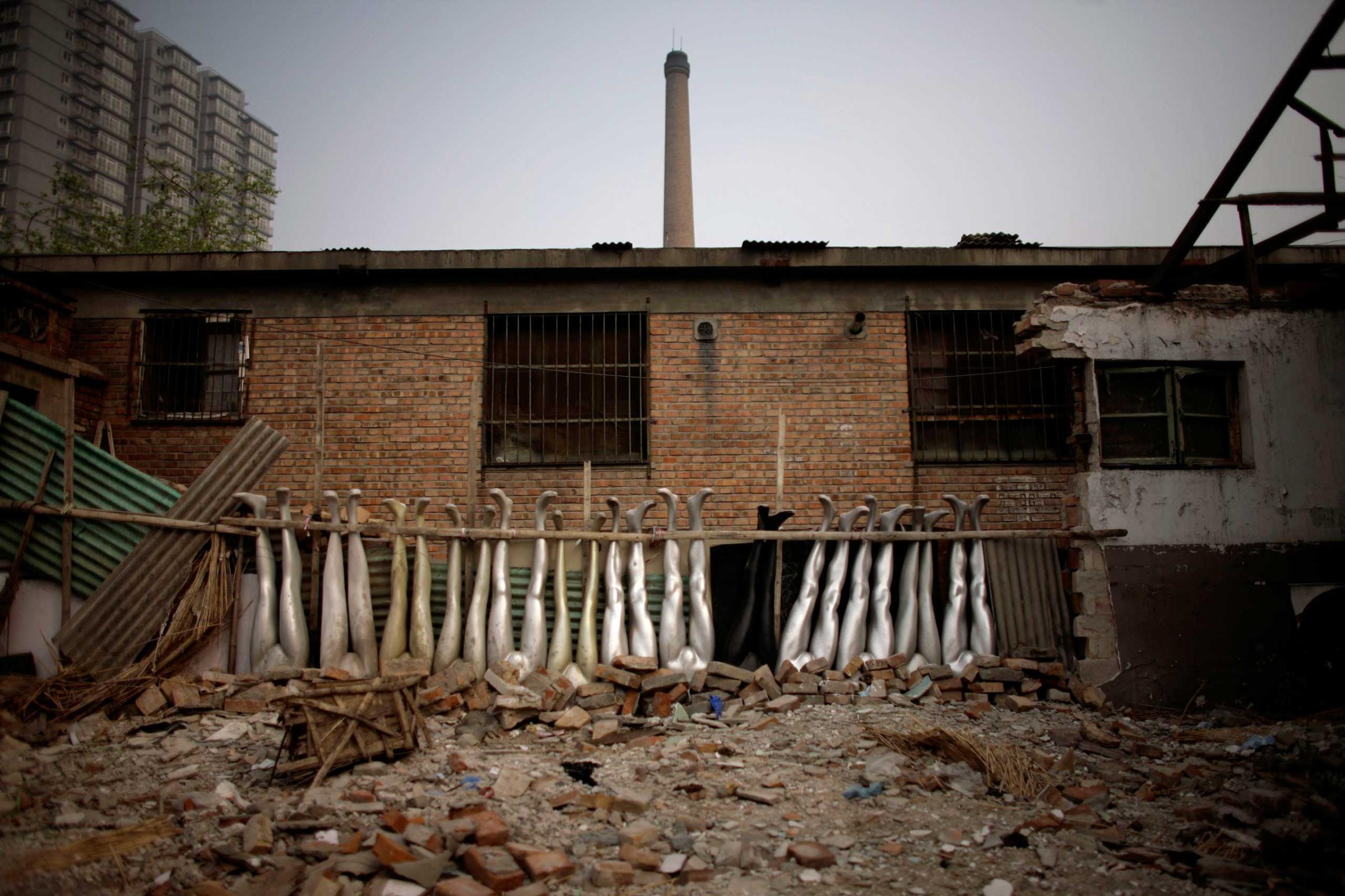 Mannequins legs lie amongst the rubble of a demolished house next to a construction site in Beijing Tuesday, April 15, 2008. China's inflation eased slightly to 8.3 percent in March, while economic growth in the first quarter of the year slowed to a still-robust 10.6 percent, the government reported Wednesday. Consumer prices rose 8.3 percent in March compared with the same month last year, down slightly from February's 8.7 percent rate, the highest in nearly 12 years, according to the National Bureau of Statistics.