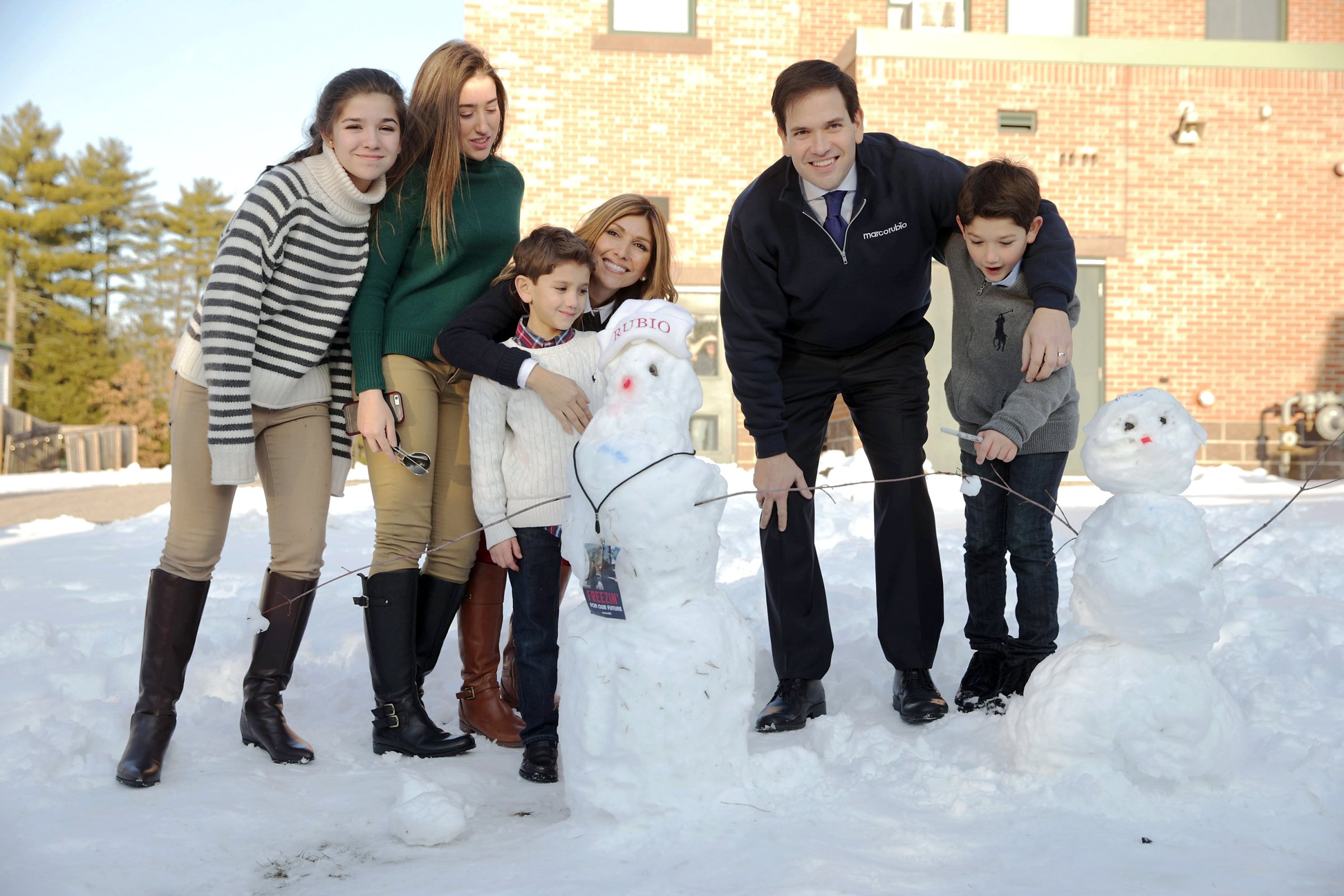 Republican presidential candidate, Florida Sen. Marco Rubio and his family, from left, daughters Daniella and Amanda, son Dominick, wife Jeanette Dousdebes Rubio and son Anthony pose for a photograph next to a snowman following a town hall meeting on Feb. 7, 2016 in Hudson, N.H.
