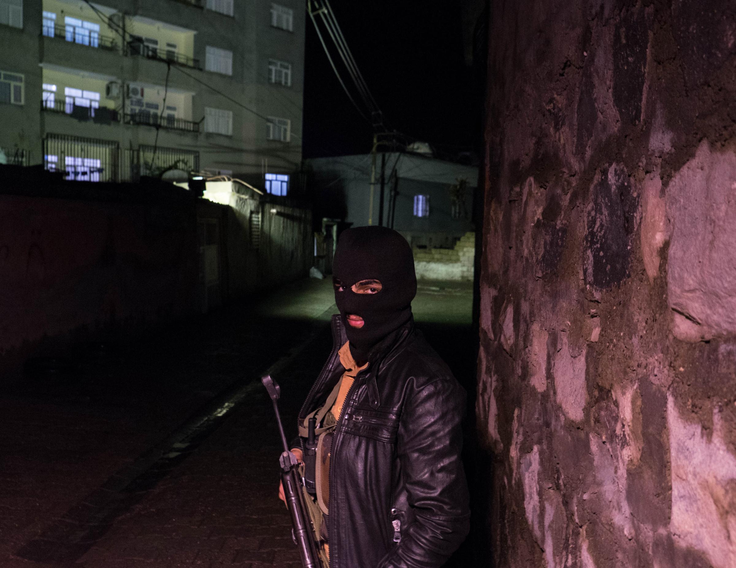 CIZRE, TURKEY - OCTOBER 28, 2015: A seventeen year old YDGH (Patriotic Revolutionary Youth Movement) at a check point in Yefes, an autonomous neighborhood of Cizre. Since July several neighborhoods declared autonomy and groups of young Kurds have taken up arms and raise barricades to prevent the advances of the Turkish forces. On August, the Turkish authorities imposed a nine days curfew during which 21 people died.