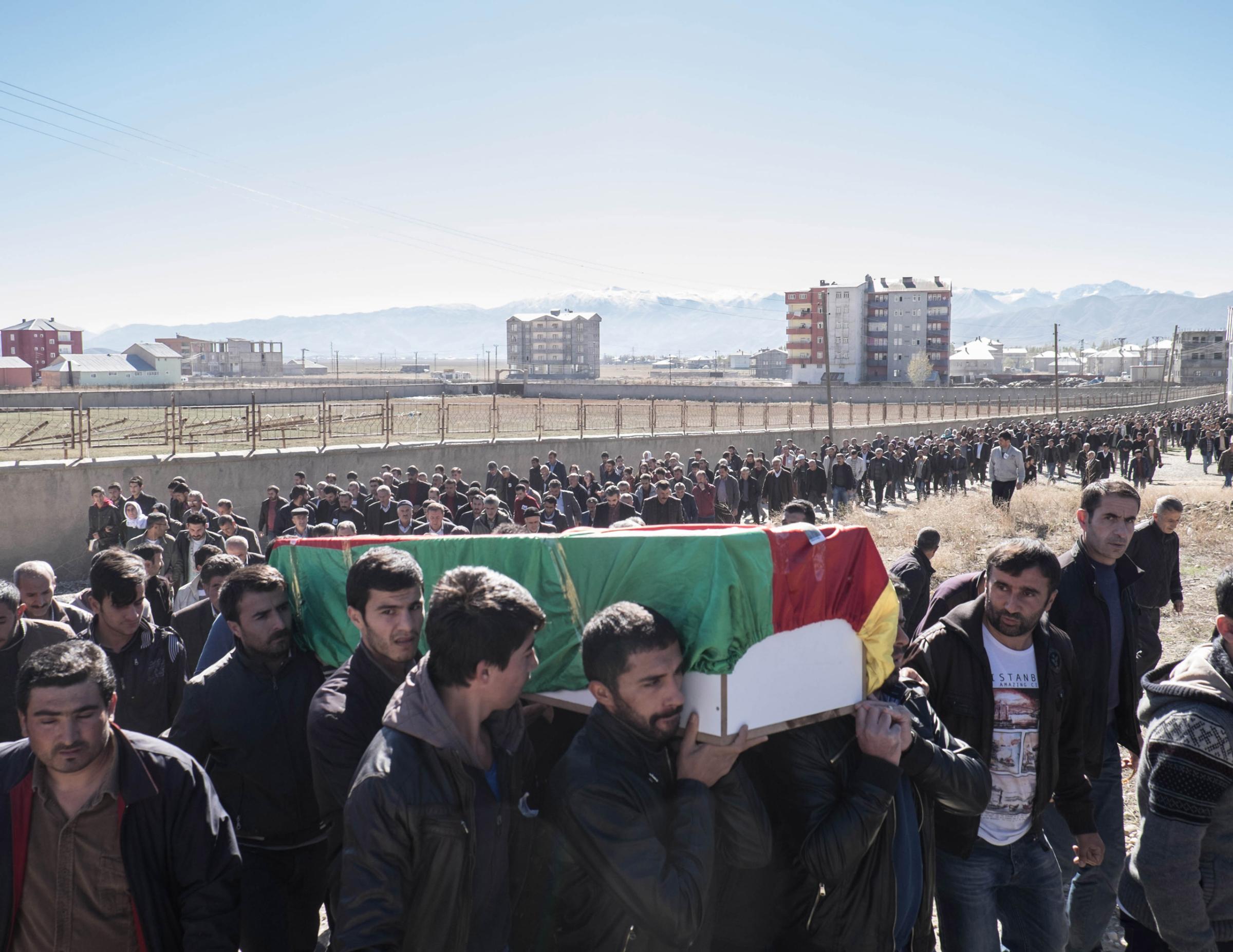 YUKSEKOVA, TURKEY - NOVEMBER 03, 2015: The funerals of Cetin Dara (18) and Dogan Dogma (20), two young Kurds shot to death by a Turkish sniper during a clash in Cumhuriyet, a self declared autonomous neighborhood in Yuksekova. Clashes broke out after that police tried to enter into the neighborhood in early morning. Since July several neighborhoods in the city have declared autonomy and built self-rules, with groups of young Kurds who have taken up arms and raise barricades to prevent the advances of the Turkish forces.