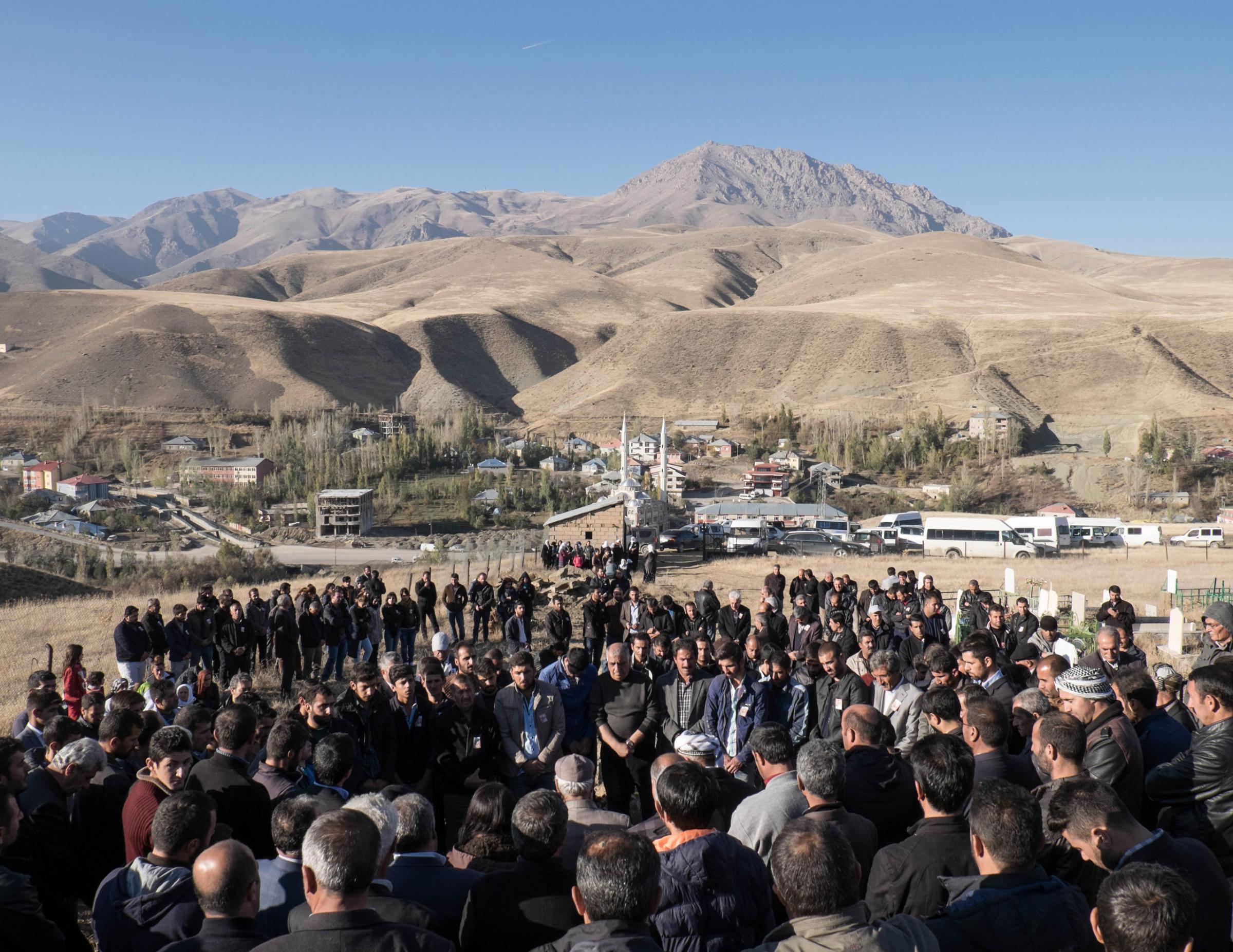 ESENDERE, TURKEY - NOVEMBER 04, 2015: The burial of Inan Tarsun, a PKK guerrilla died recently during a clash with the Turkish army on the Qandil mountains. Relatives and friends commemorate his death at the PKK grave yard in Esendere, a small town a the border with Iran in the Hakkari province. Since July the region has seen a surge in violence with daily clashes between the Turkish army and the militants from the outlawed Kurdistan Workers Party (PKK). The escalation has shattered a two-year ceasefire that had raised hopes of an end to three decades of fighting, in which more than 40,000 people have been killed.