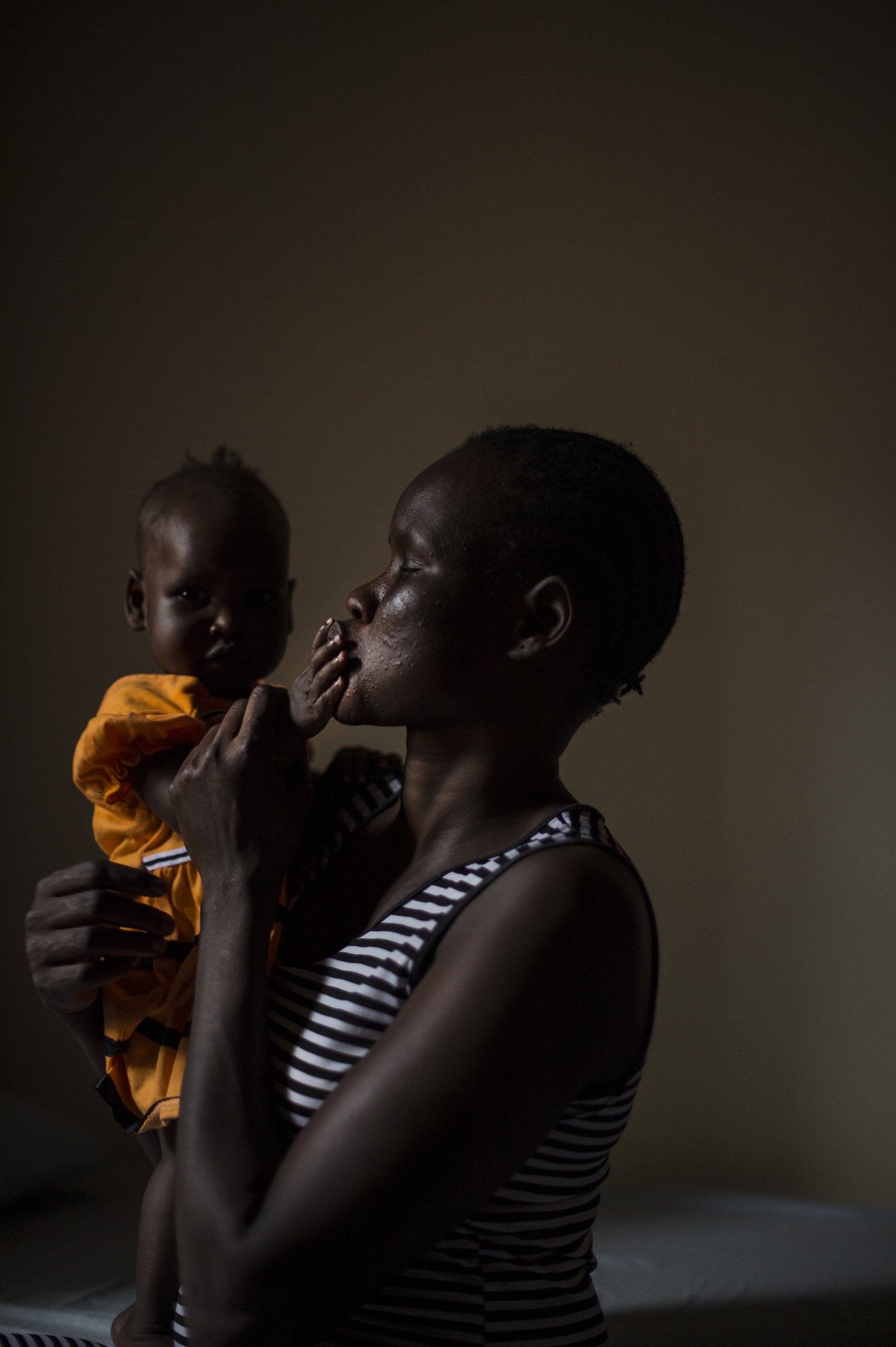 Mary, 27, holds her daughter, Nyakwat, 6 months old who was born after Mary was raped repeatedly at a U.N. camp in South Sudan by different men. She now lives in a safe house in Uganda, Dec. 8, 2015. Mary, a member of the Nuer tribe, watched as her husband and her two sons were killed in front of her by soldiers of the Dinka tribe. Five of them held her down as three others raped her 10-year-old daughter who died hours later. The soldiers, who also raped Mary, told her that they considered the Nuers in the camps to be rebels, and that they killed her sons because they couldn’t risk letting them grow up to be fighters. Mary made her way to a U.N. camp for civilians displaced by war where she lived for a year and was raped by soldiers who made their way into the camp. Since December 2013, the new country of South Sudan has been roiled by a vicious power struggle between President Salva Kiir, a member of the Dinka tribe, and his Vice President, Riek Machar, a Nuer. Their war, fought largely along ethnic lines, has turned the northern part of the country into a wasteland.