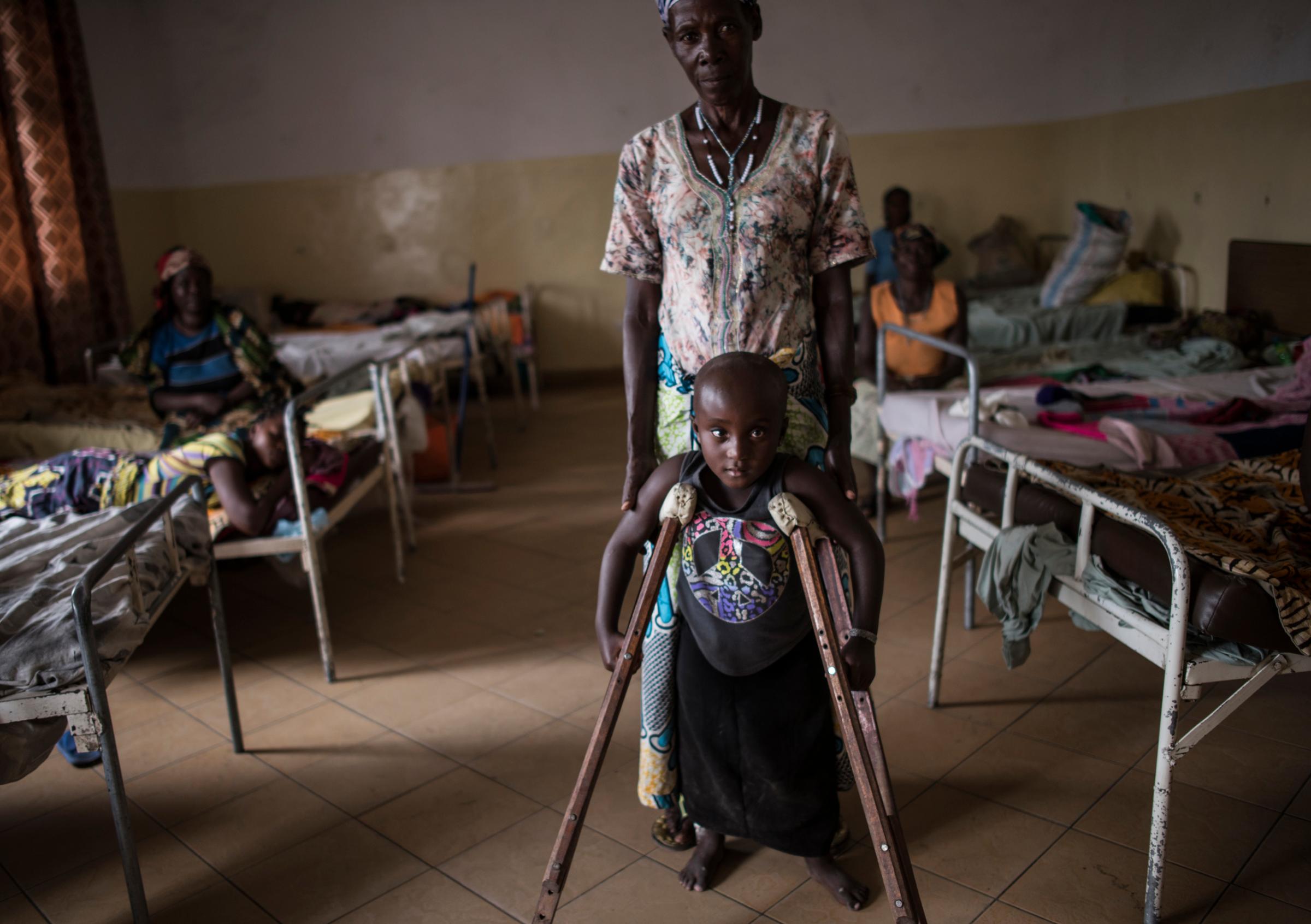 Kanyere Neema, 7, with her grandmother, Ndahondi Domina, 53, in the Heal Africa hospital in Goma, the Democratic Republic of Congo, Dec. 5, 2015. Two years prior, Kanyere's village of Ishasha was attacked by armed men, and her parents were killed in front of her. She was raped so many times by different men that she was left paralyzed, and stopped speaking.