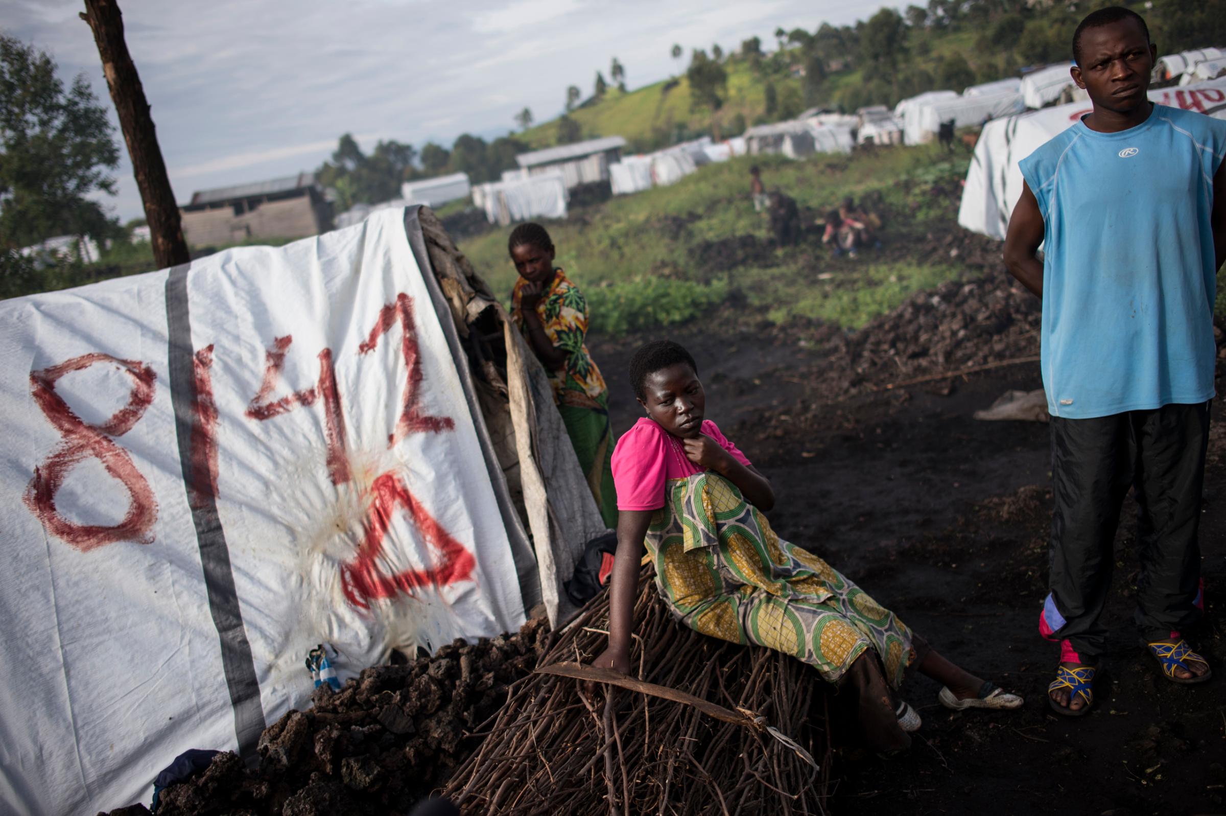 Maiombi Thomas,16 , sits alongside her brother, Innocent kongomani, 22, in the Mugunga 1 camp for internally displaced people, outside Goma, the Democratic Republic of Congo, December 5, 2015. Maiombi became pregnant after she was raped by a ranger when she went to get firewood outside the camp.