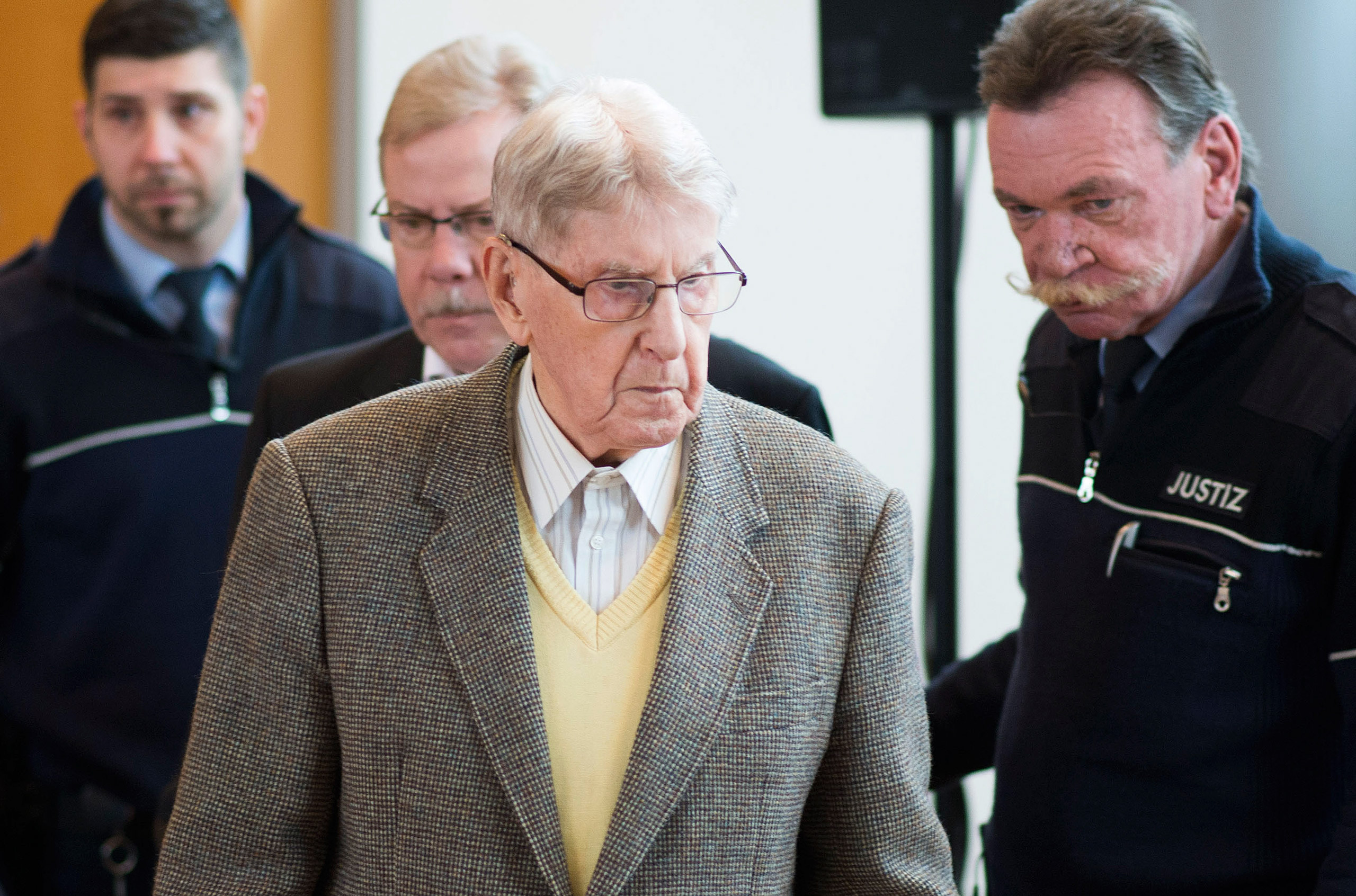 Hanning, a 94-year-old former guard at Auschwitz, arrives in the courtroom before his trial in Detmold