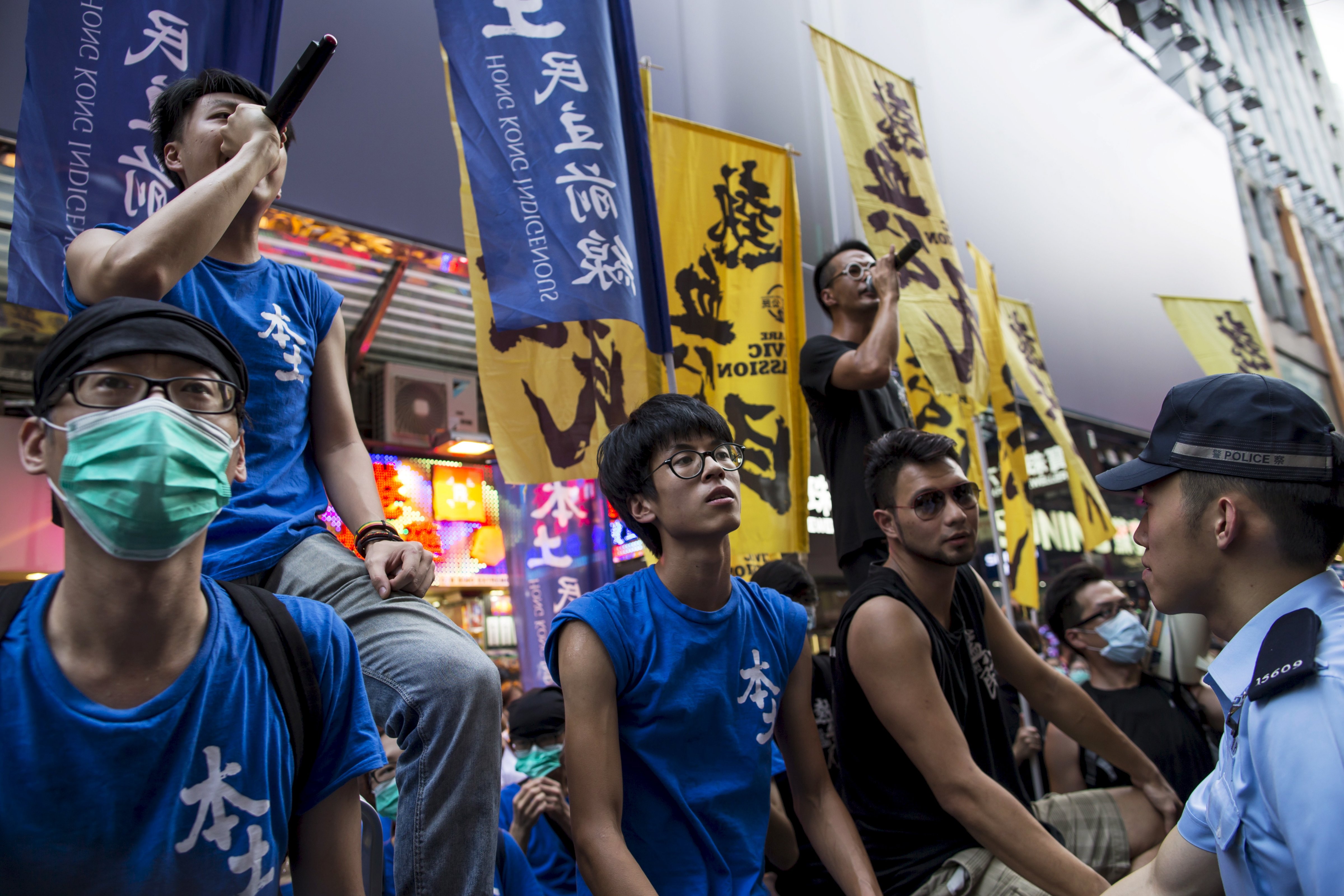 Localist protesters shout to pro-China demonstrators during an anti-China protest at Mongkok shopping district in Hong Kong, China