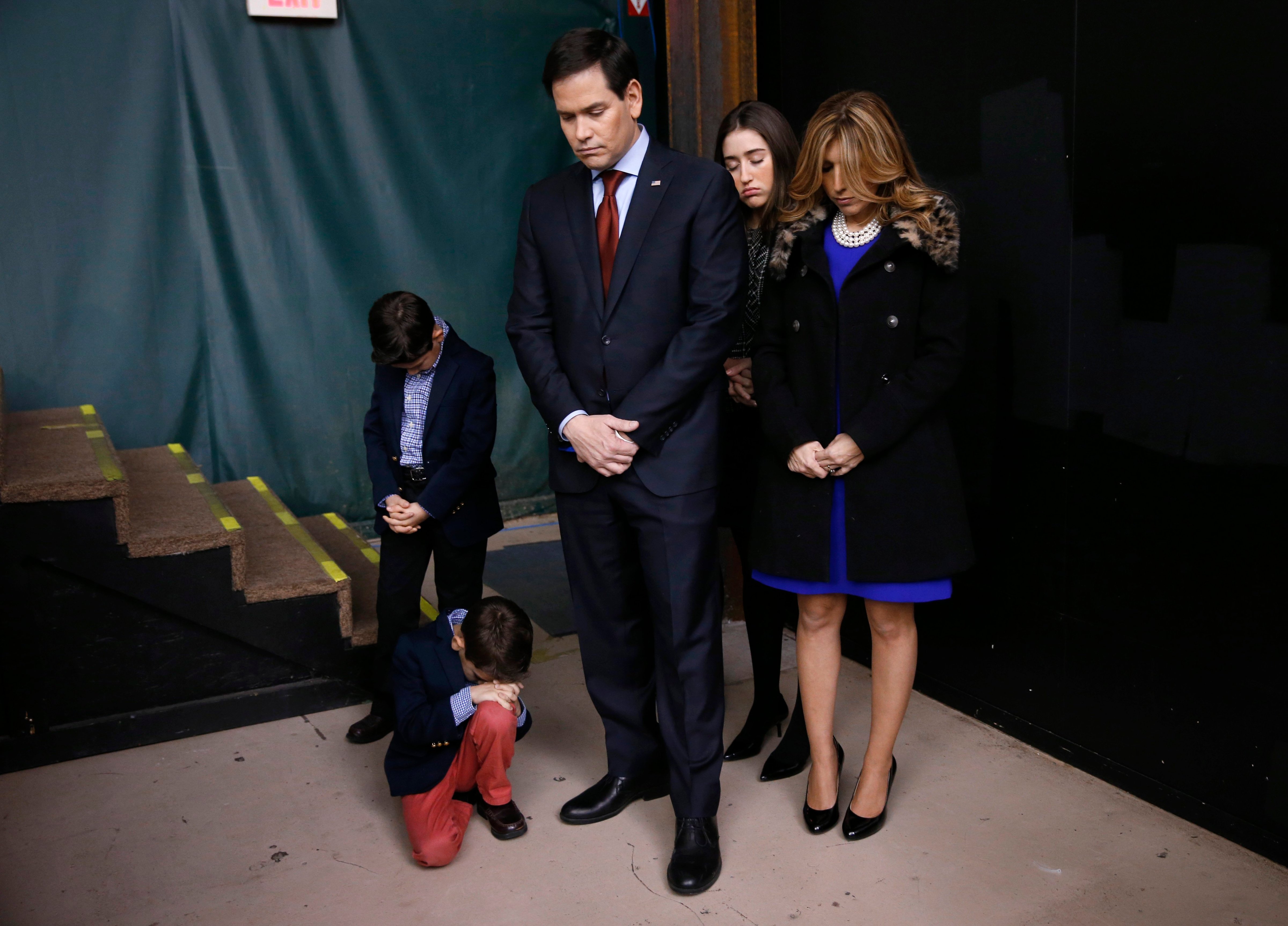 Republican presidential candidate Sen. Marco Rubio and his family pray during opening of a caucus site, Feb. 1, 2016 in Clive, Iowa. (Paul Sancya—AP)