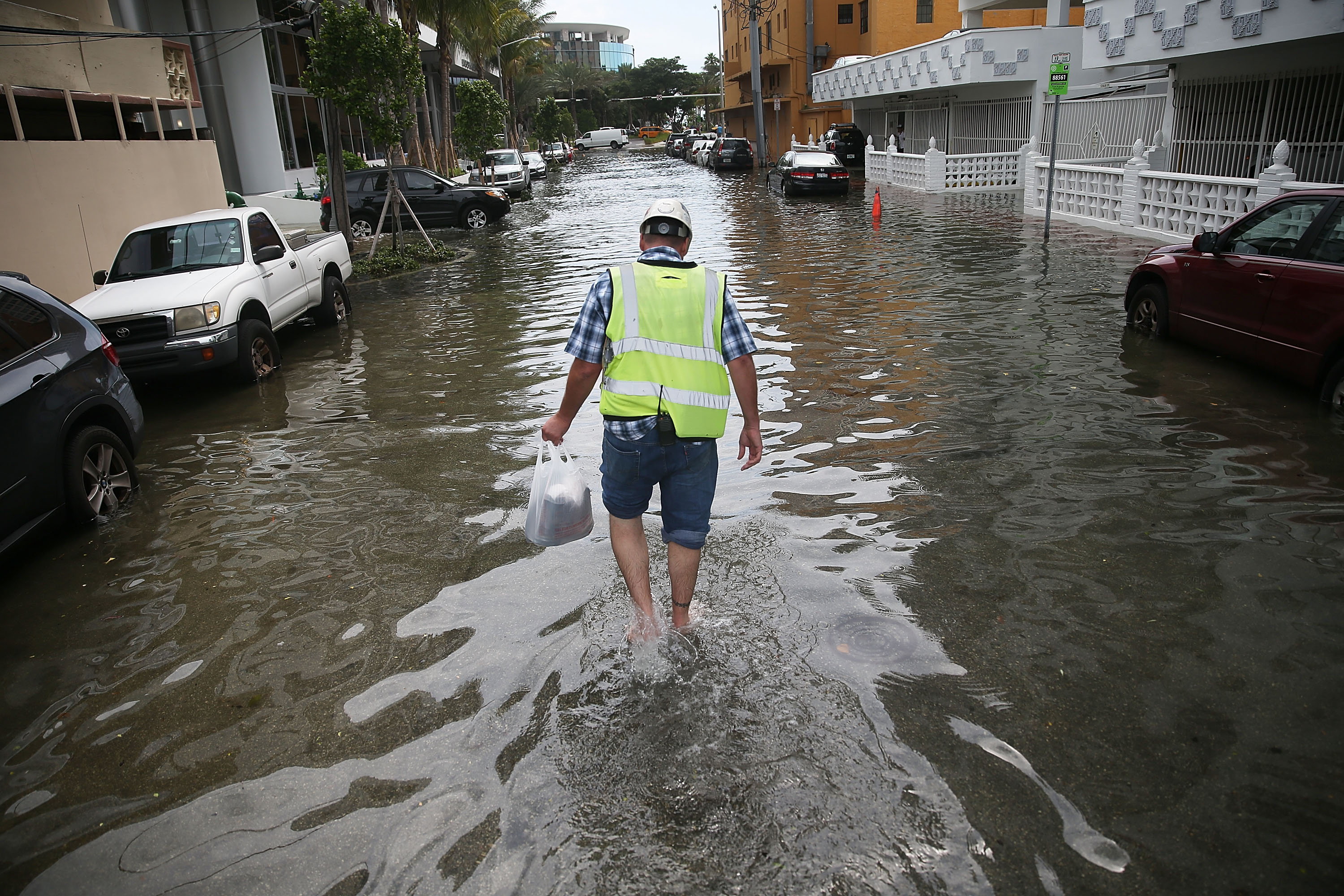 A man walks through a flooded street in Miami in Sept. 2015 (Joe Raedle—Getty Images)