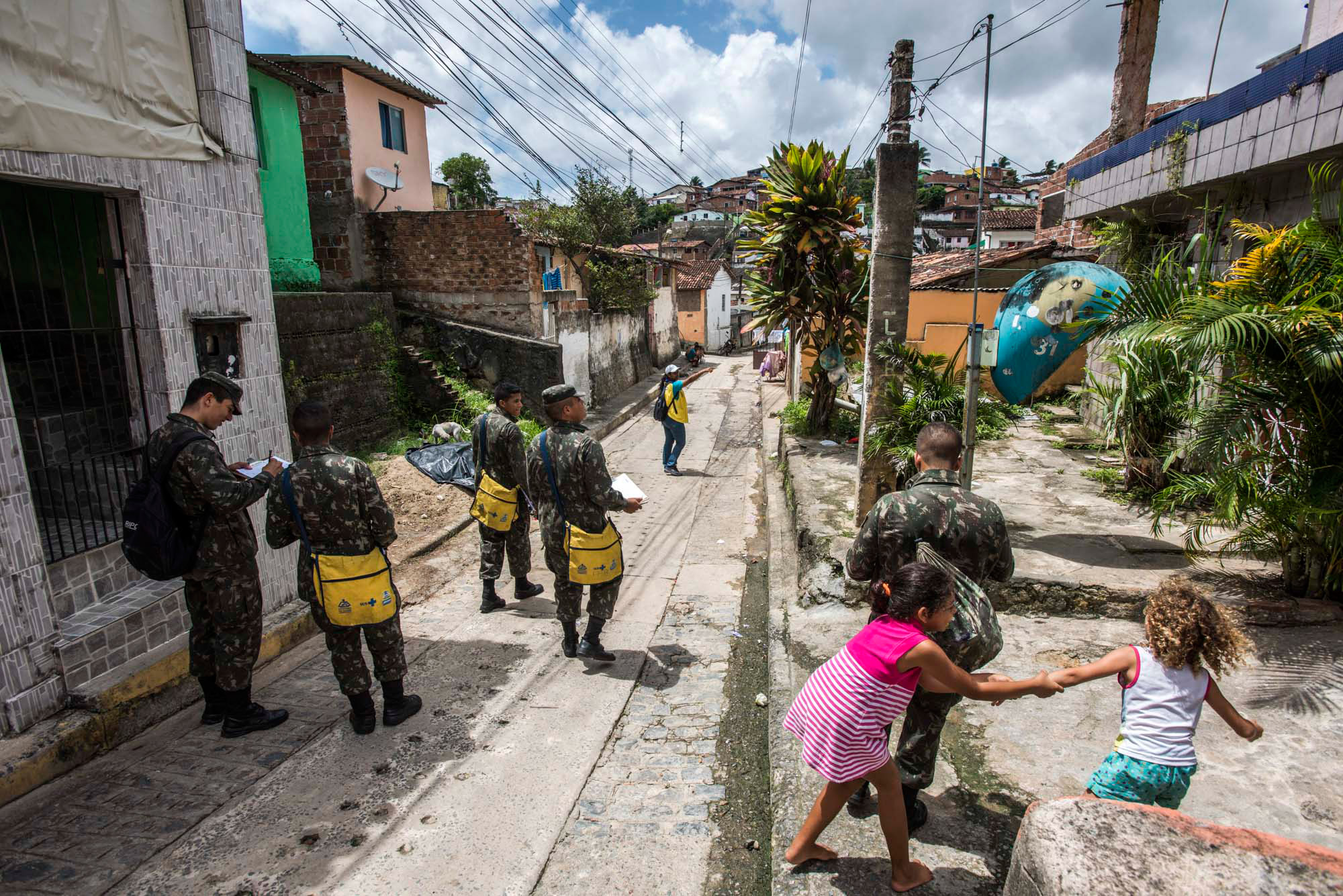 Members of the military walk the streets of the Nova Descoberta neighborhood in a campaign to prevent the transmission of the Zika virus in Recife, Brazil, Feb. 2, 2016.