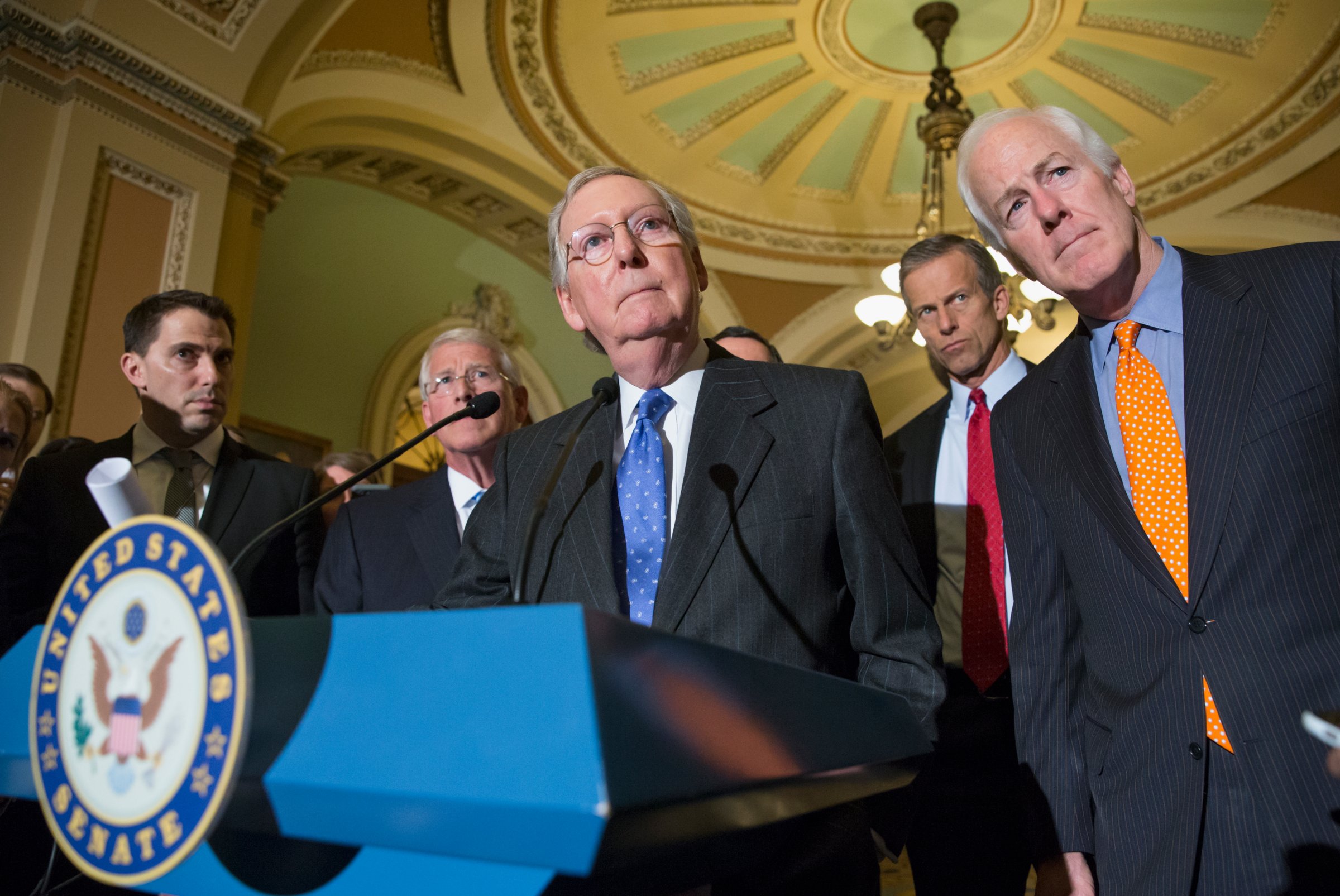 Mitch McConnell, center, speaks with reporters on Capitol Hill in Washington, D.C. on Feb. 23, 2016.