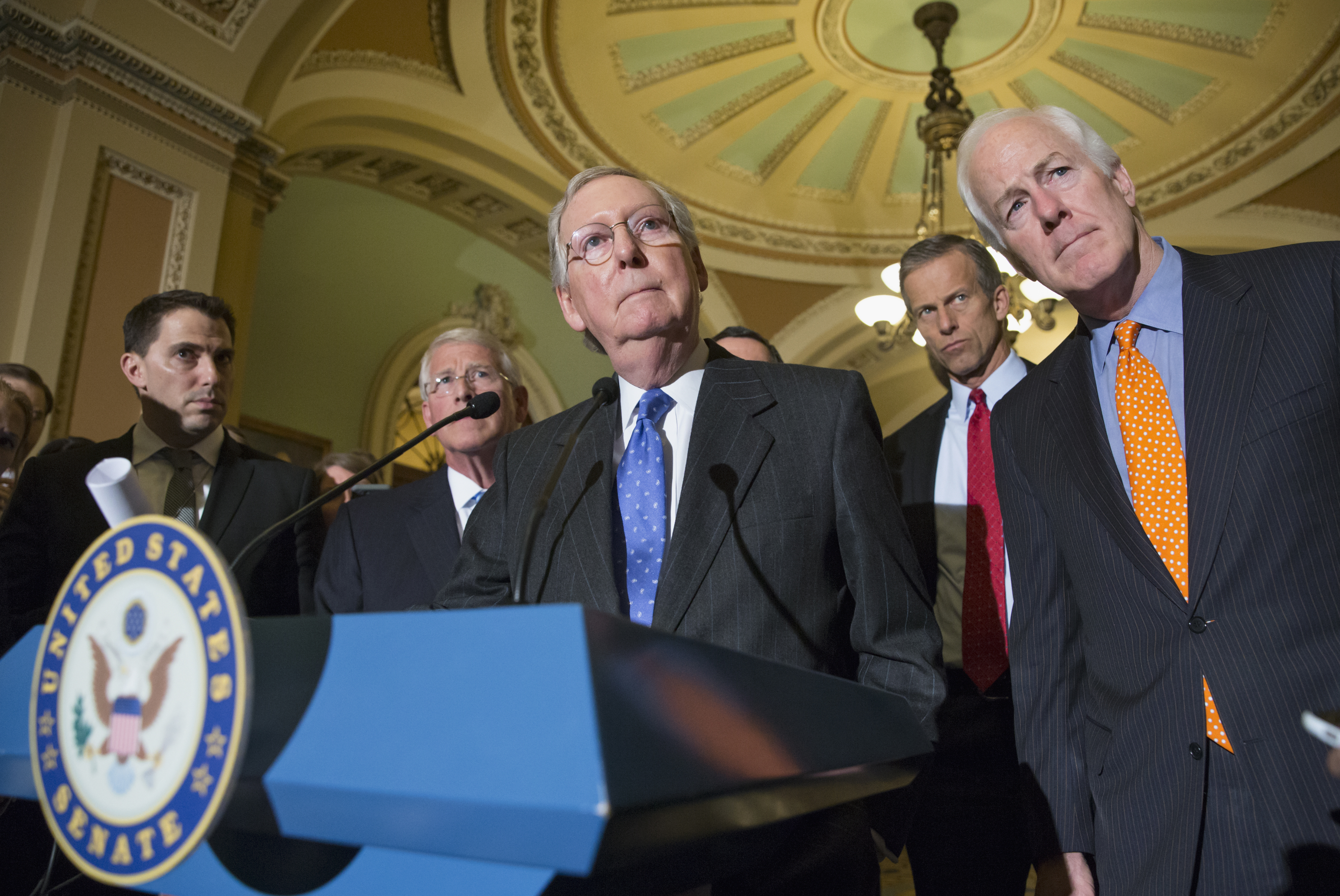 Mitch McConnell, center, speaks with reporters on Capitol Hill in Washington, D.C. on Feb. 23, 2016. (J. Scott Applewhite—AP)