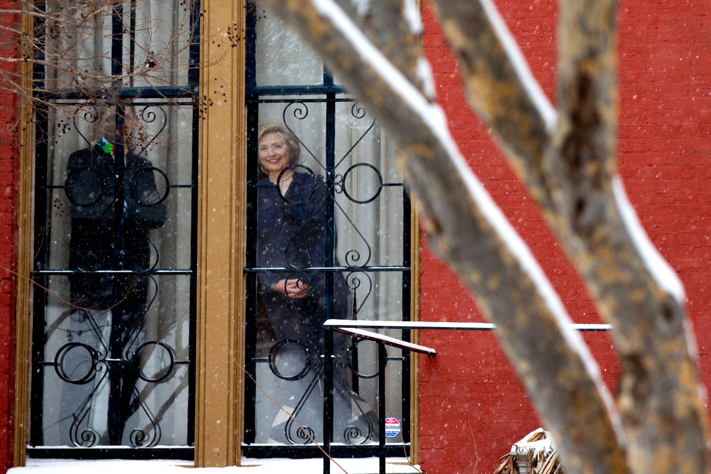 Cardboard cutouts of Democratic presidential candidate Hillary Clinton , right, and President Barack Obama are positioned in a window in the LeDroit Park neighborhood in Washington on Feb. 15, 2016.