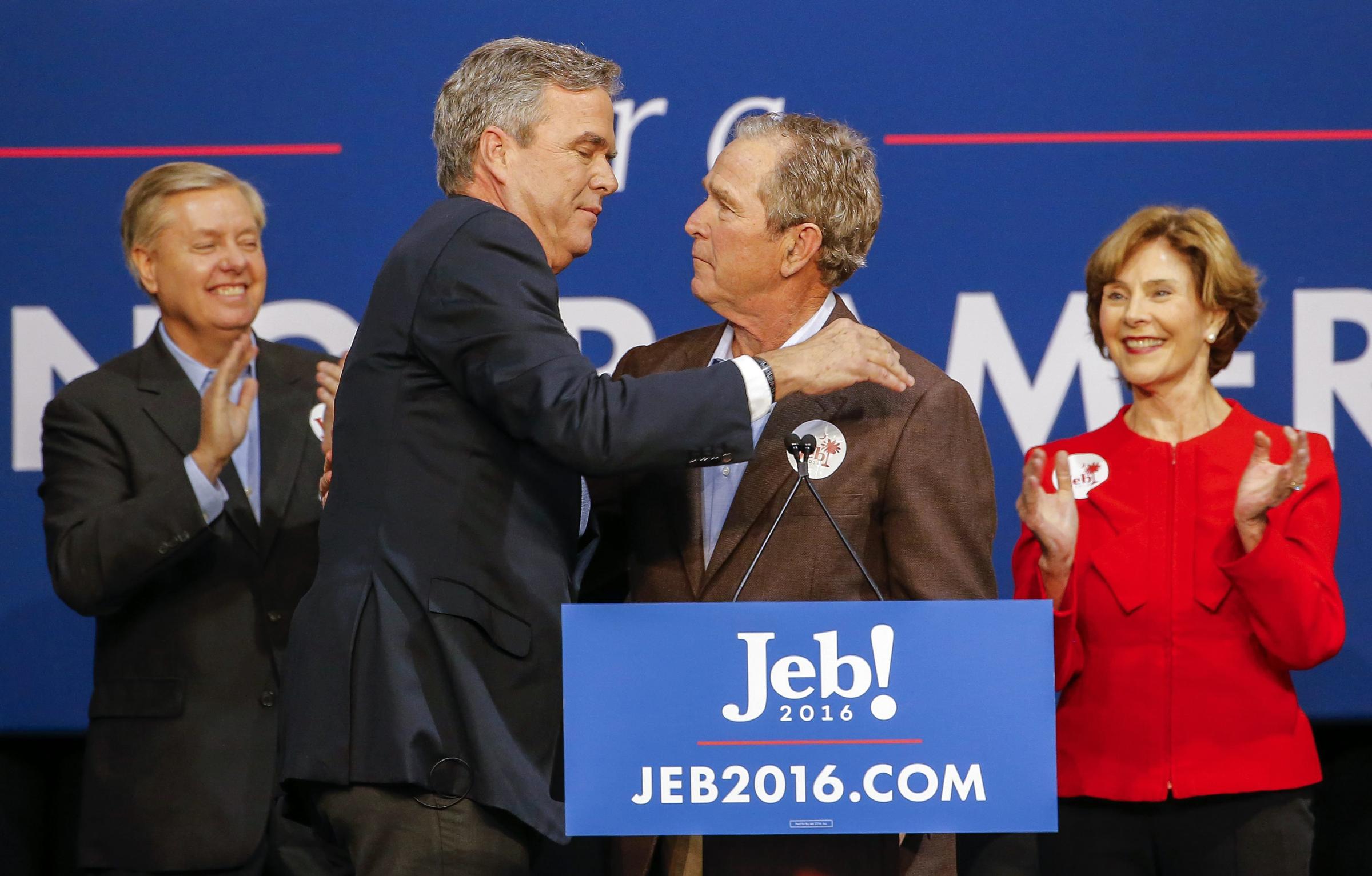 Republican presidential candidate and former Florida Gov. Jeb Bush, center left, participates in a campaign event with his brother, former U.S. President George W. Bush in North Charleston, S.C. on Feb. 15, 2016. Former First Lady Laura Bush, right, and South Carolina Senator Lindsey Graham, left, appear on stage.