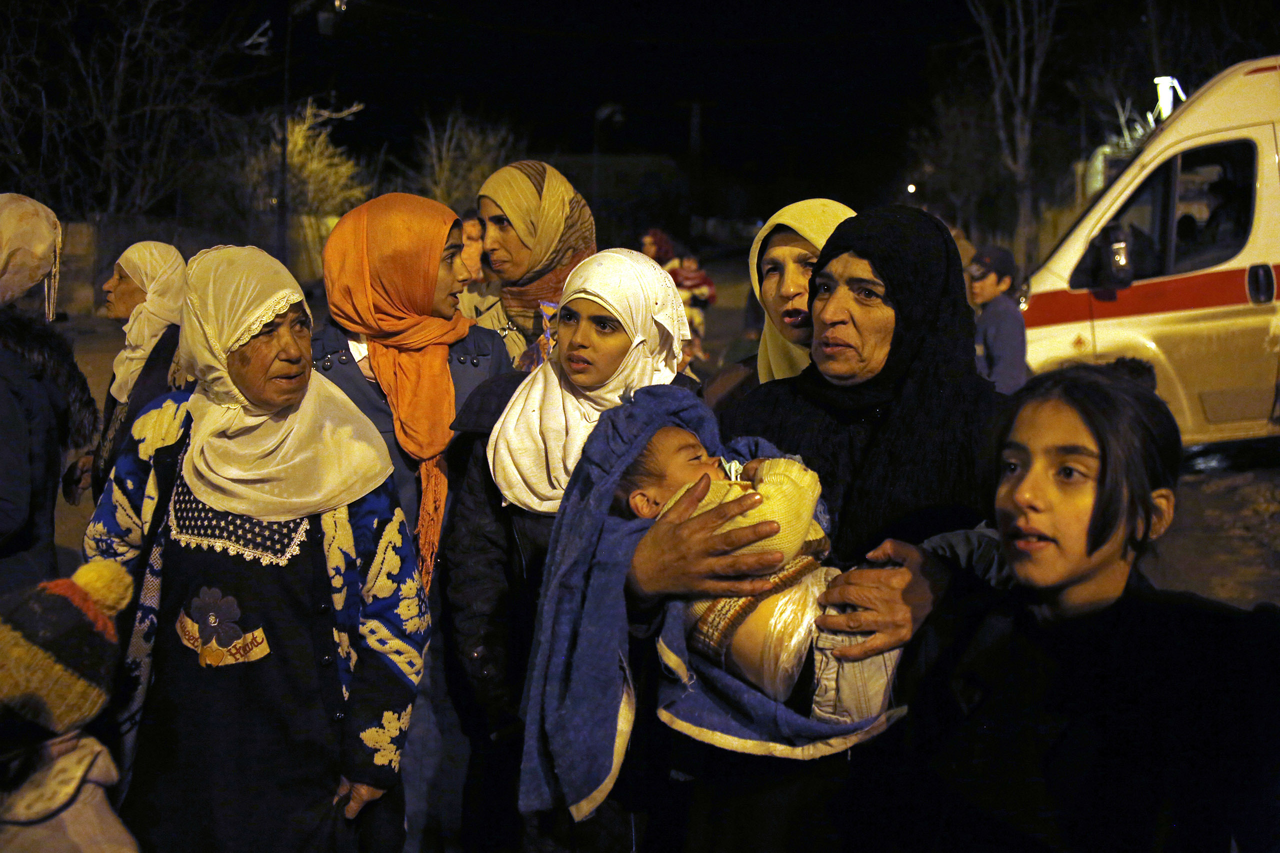 In this Jan. 11, 2016, photo, a group of women and young children wait to leave the besieged town of Madaya, northwest of Damascus, Syria. Doctors Without Borders says dozens of people in Madaya have died of starvation since September. (AP)