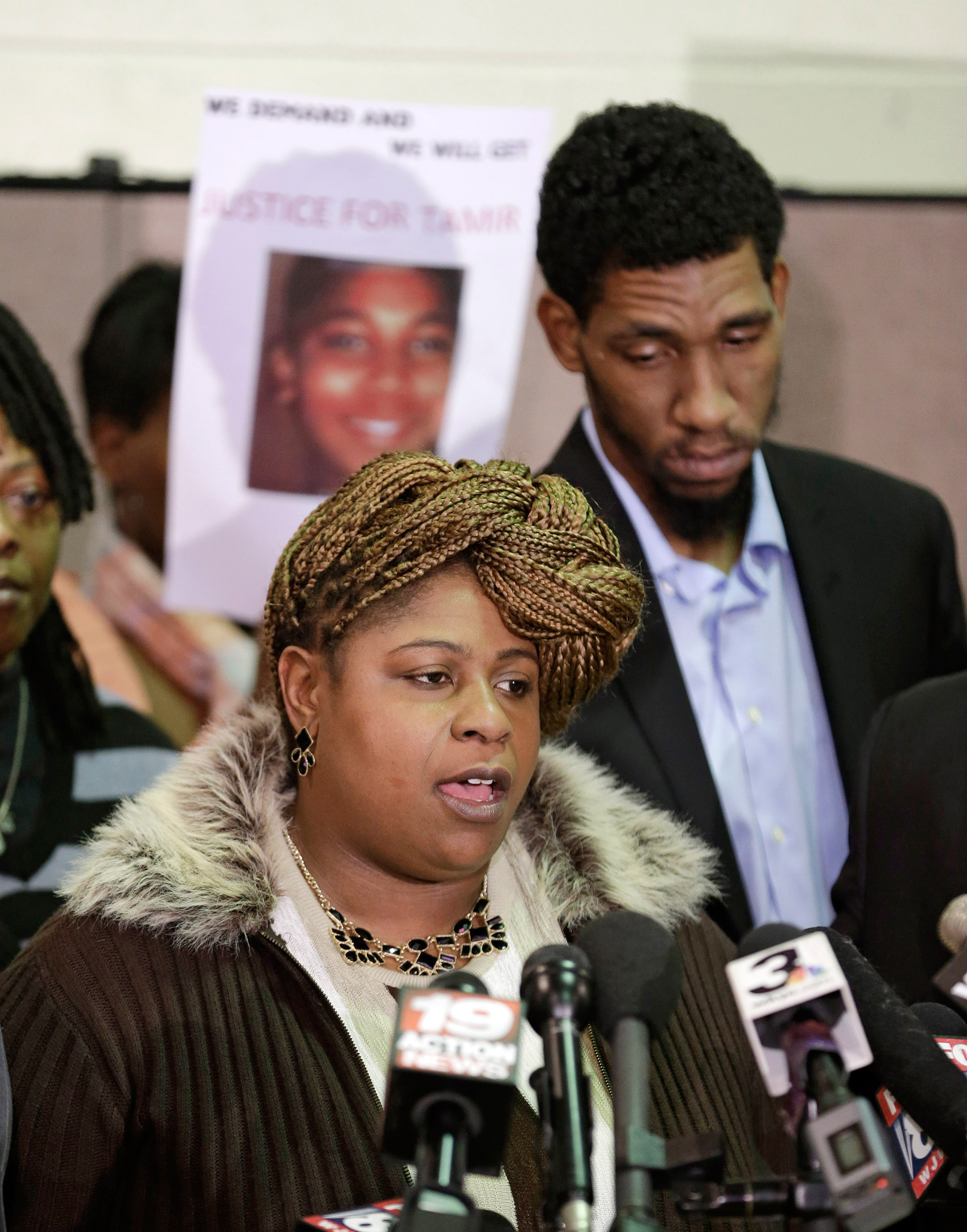 Samaria Rice, mother of Tamir, the 12-year-old boy who was fatally shot by a Cleveland police officer, speaks as Leonard Warner, Tamir's father, listens during a news conference in Cleveland, Ohio, Dec. 8, 2014.
