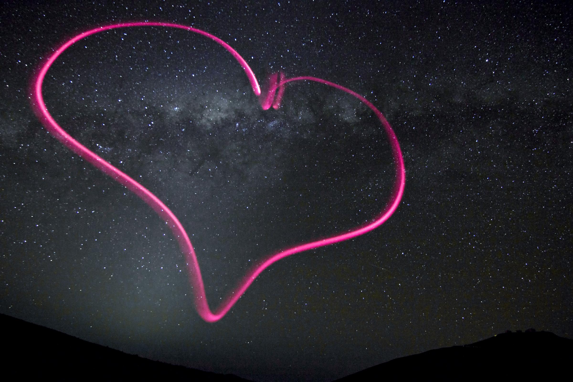 A bright pink symbol of love appears against the backdrop of the night sky over ESO's Paranal Observatory in northern Chile, released on Feb.13, 2012. Julien Girard drew the heart in the air by shining a tiny flashlight keychain at the camera during a 25-second exposure with a tripod. The central region of the Milky Way appears in the middle of the heart, as the plane of our galaxy stretches across the image.