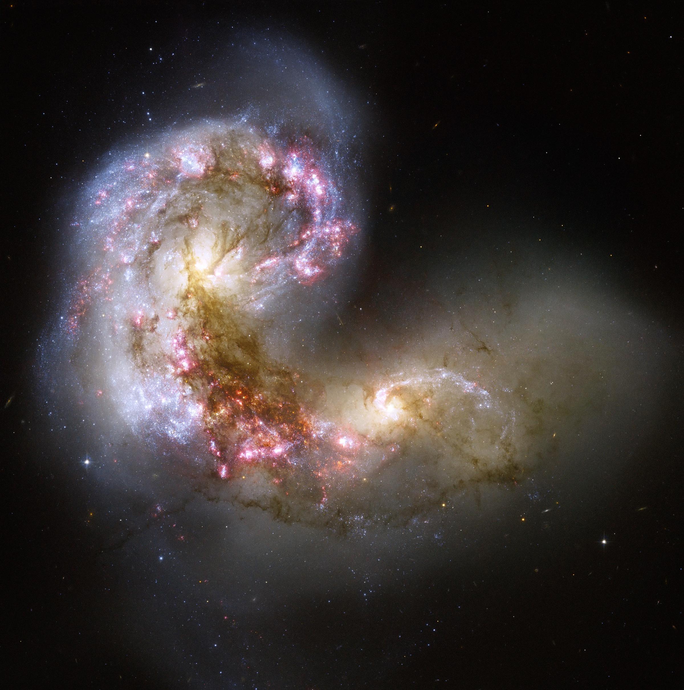 This Hubble image taken in Aug. 2012, of the Antennae galaxies is the sharpest yet of this merging pair of galaxies. As the two galaxies smash together, billions of stars are born, mostly in groups and clusters of stars. The brightest and most compact of these are called super star clusters.