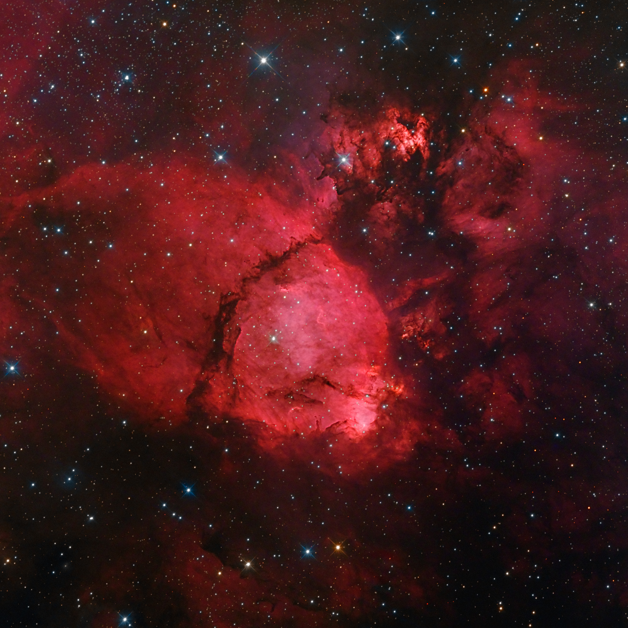 A sharp cosmic portrait features glowing gas and obscuring dust clouds in IC 1795, a star forming region in the northern constellation Cassiopeia. The nebula's remarkable details, shown in its dominant red color, were captured using a sensitive camera, and long exposures that include image data from a narrowband filter taken from Eagle Ridge Observatory in Calif. on Sept. 26-27, 2011.