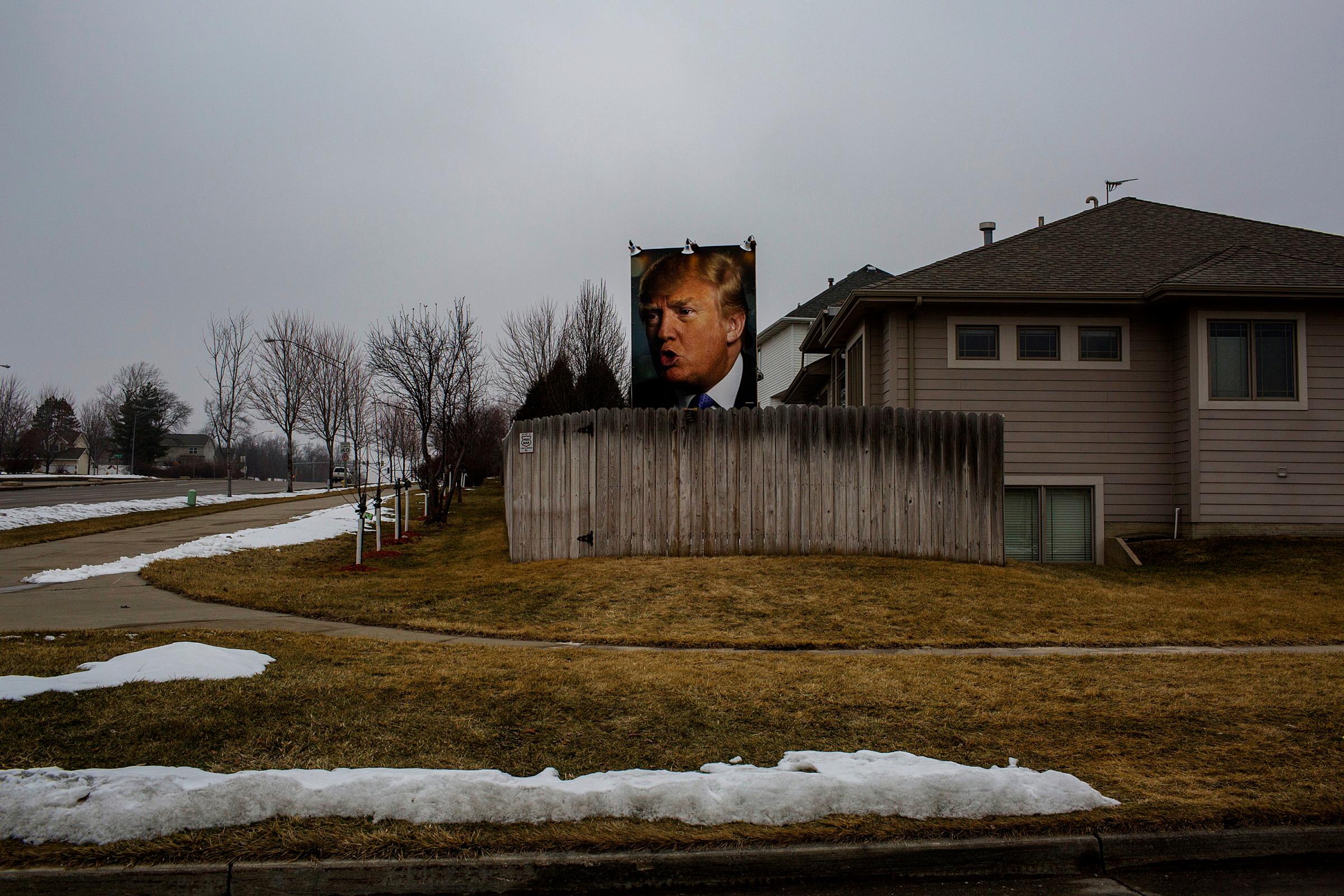 A poster depicting Republican Presidential candidate Donald Trump is mounted on a lawn in West Des Moine, Iowa, on Jan. 25, 2016.