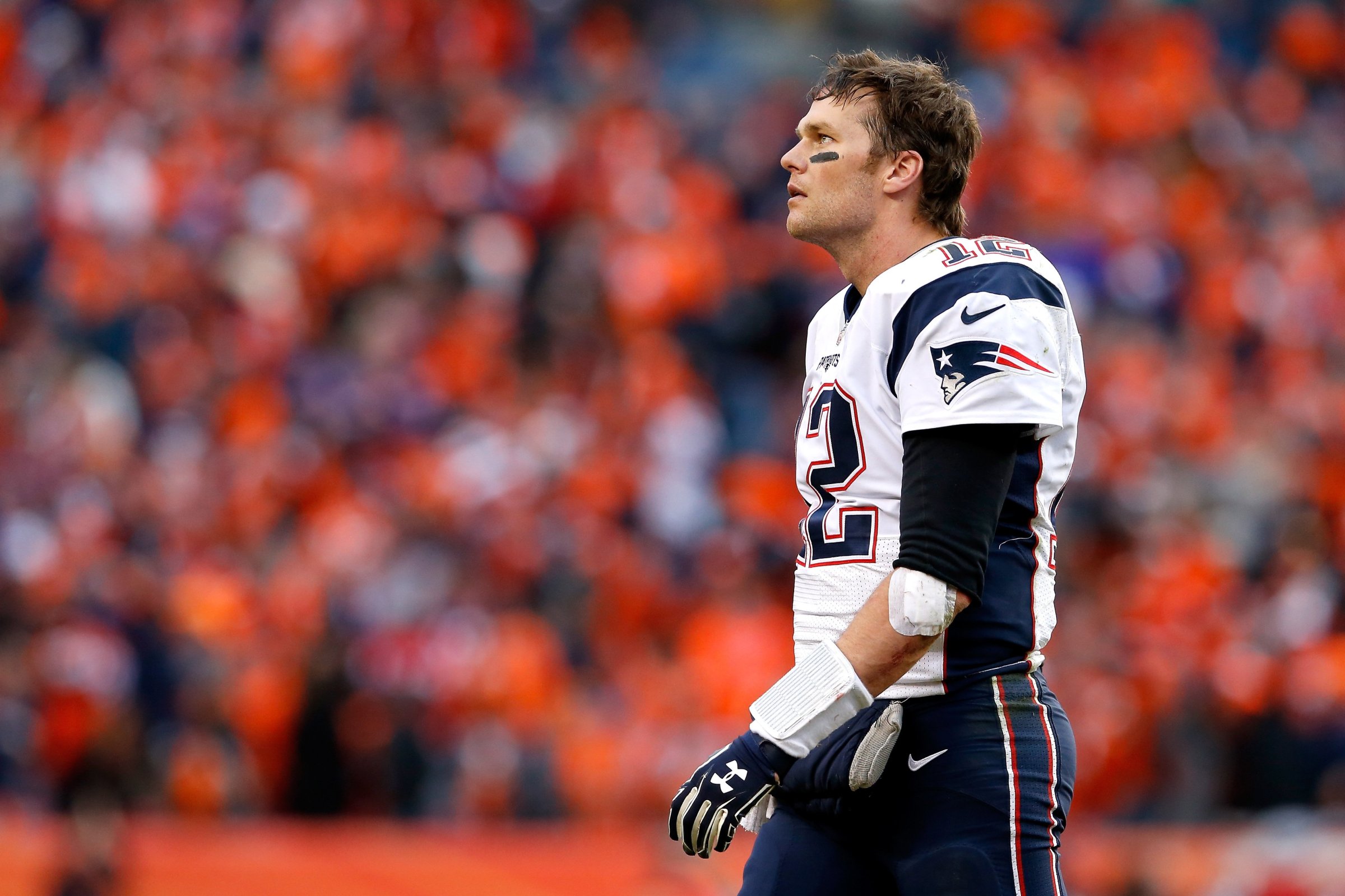 Tom Brady #12 of the New England Patriots walks off the field in the fourth quarter against the Denver Broncos in the AFC Championship game at Sports Authority Field at Mile High in Denver on Jan. 24, 2016.