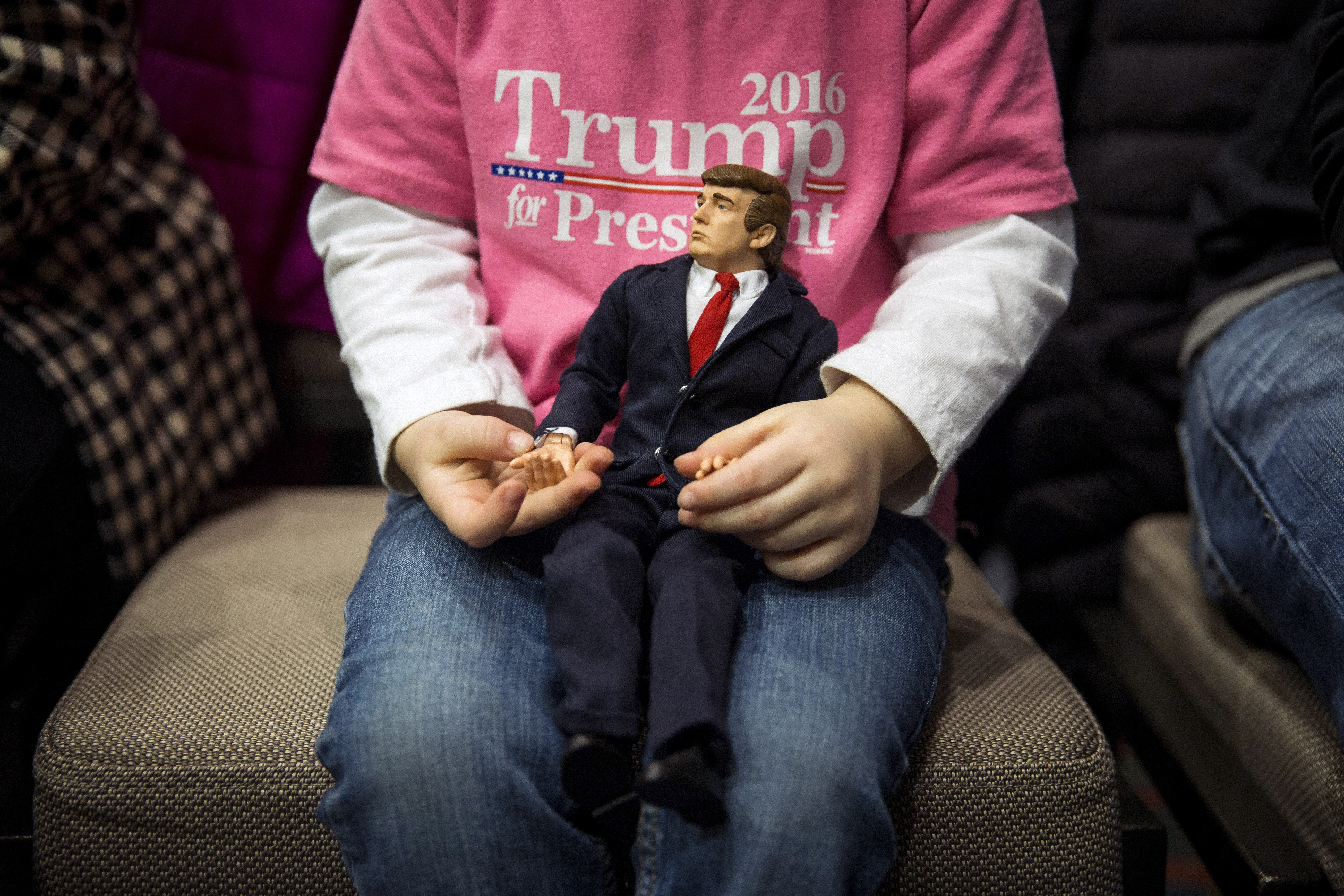 Charlee Dotson, 3, plays with a Donald Trump action figure before a campaign event for Trump in Cedar Rapids, Iowa, on Feb. 1, 2016.