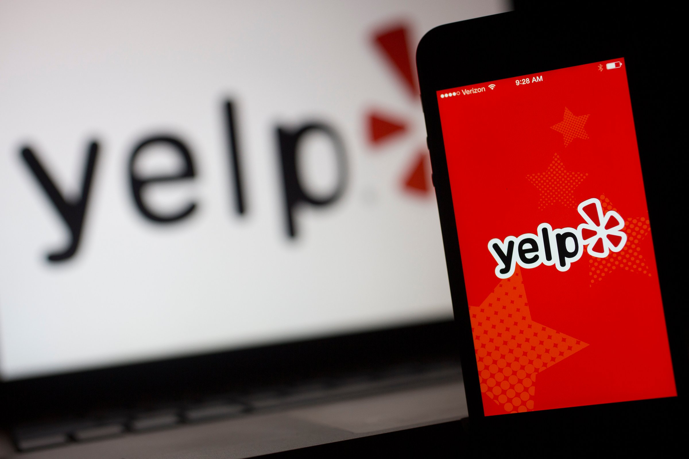 The Yelp Inc. application and logo are displayed on an Apple Inc. iPhone 5s and iPad Air in this arranged photograph in Washington, D.C., U.S., on Friday, April 25, 2014.