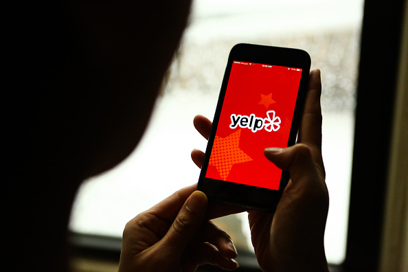 The Yelp Inc. application is displayed on an Apple Inc. iPhone .