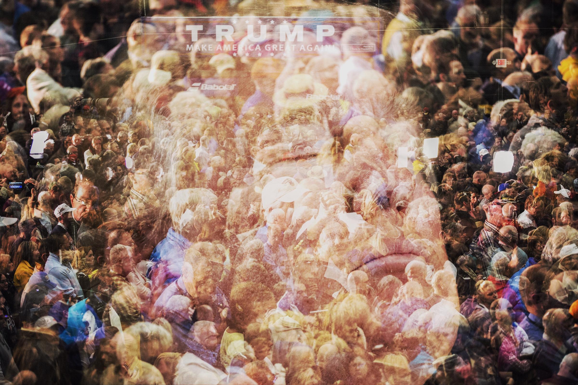 In this double exposure, Republican presidential candidate Donald Trump speaks to a crowd of supporters at a campaign rally in Milford, N.H. on Feb. 2, 2016.
