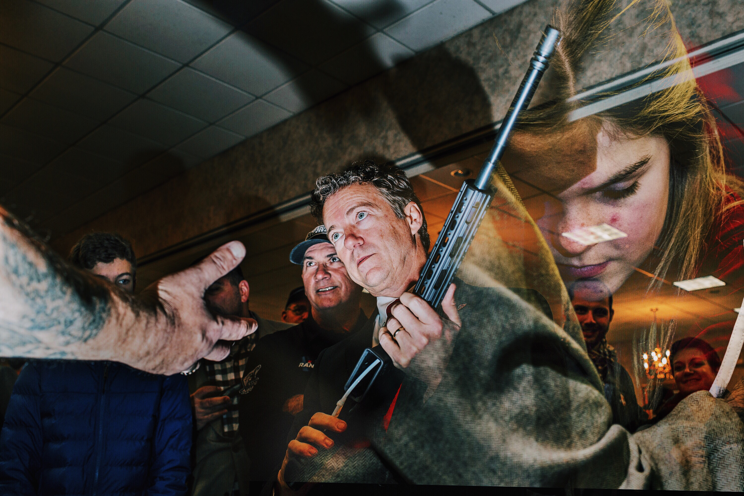 Republican presidential candidate Rand Paul holds a custom-made rifle at a gun show in Concord, N.H. during a campaign stop on Jan. 23, 2016.