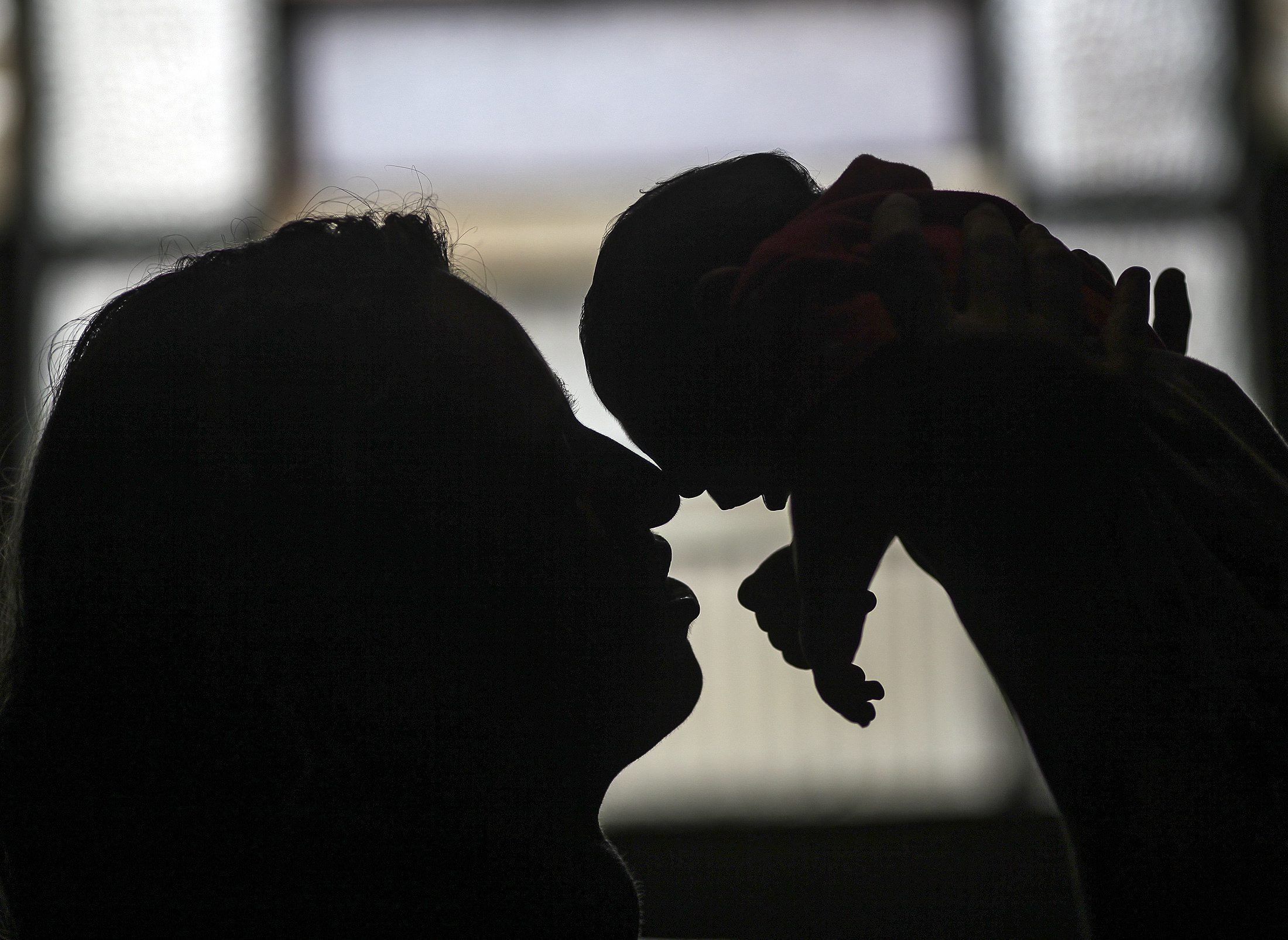 Patricia Vieira de Araujo holding her granddaughter, who was born with microcephaly in Rio de Janeiro, on Feb. 11, 2015. (Antonio Lacerda—EPA)
