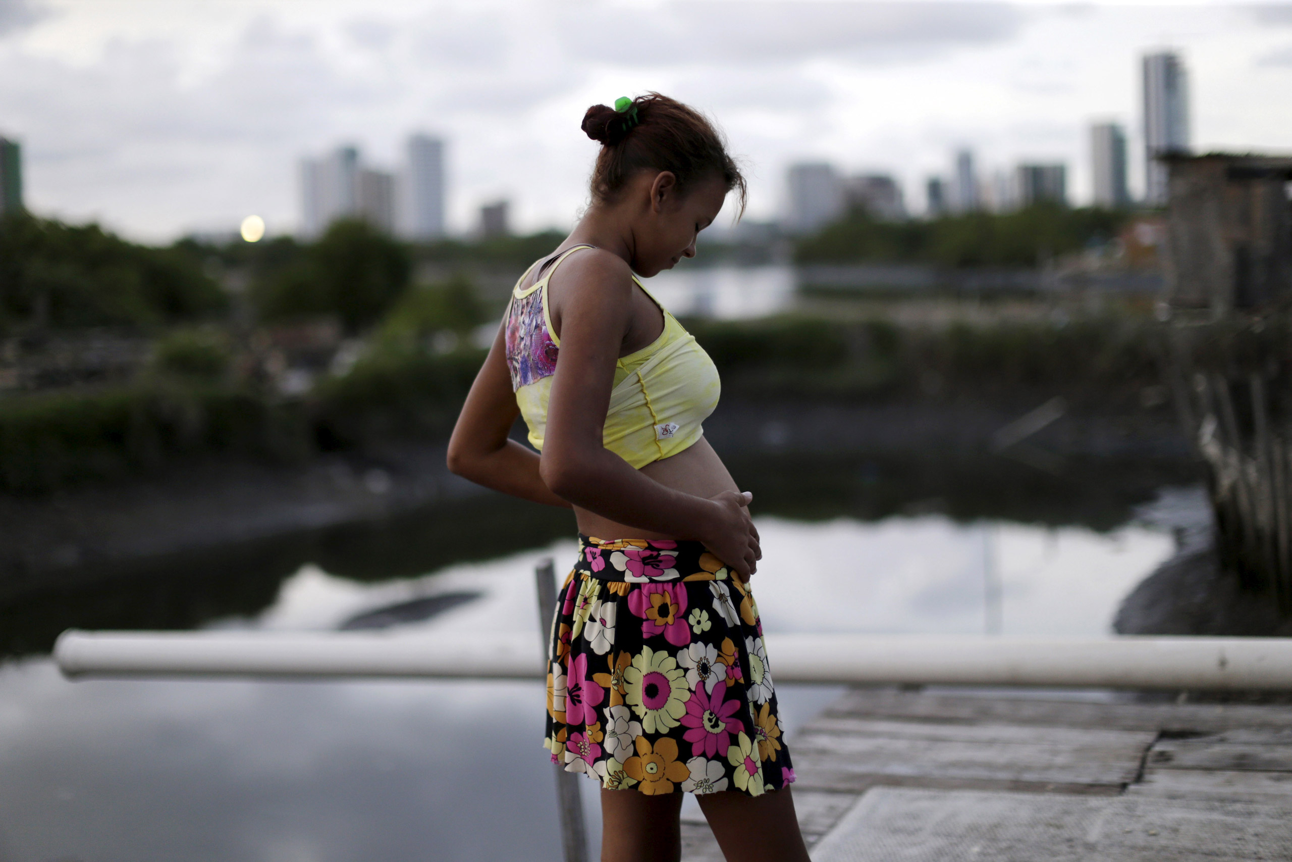 Eritania Maria, who is six months pregnant, is seen in front of her house at a slum in Recife