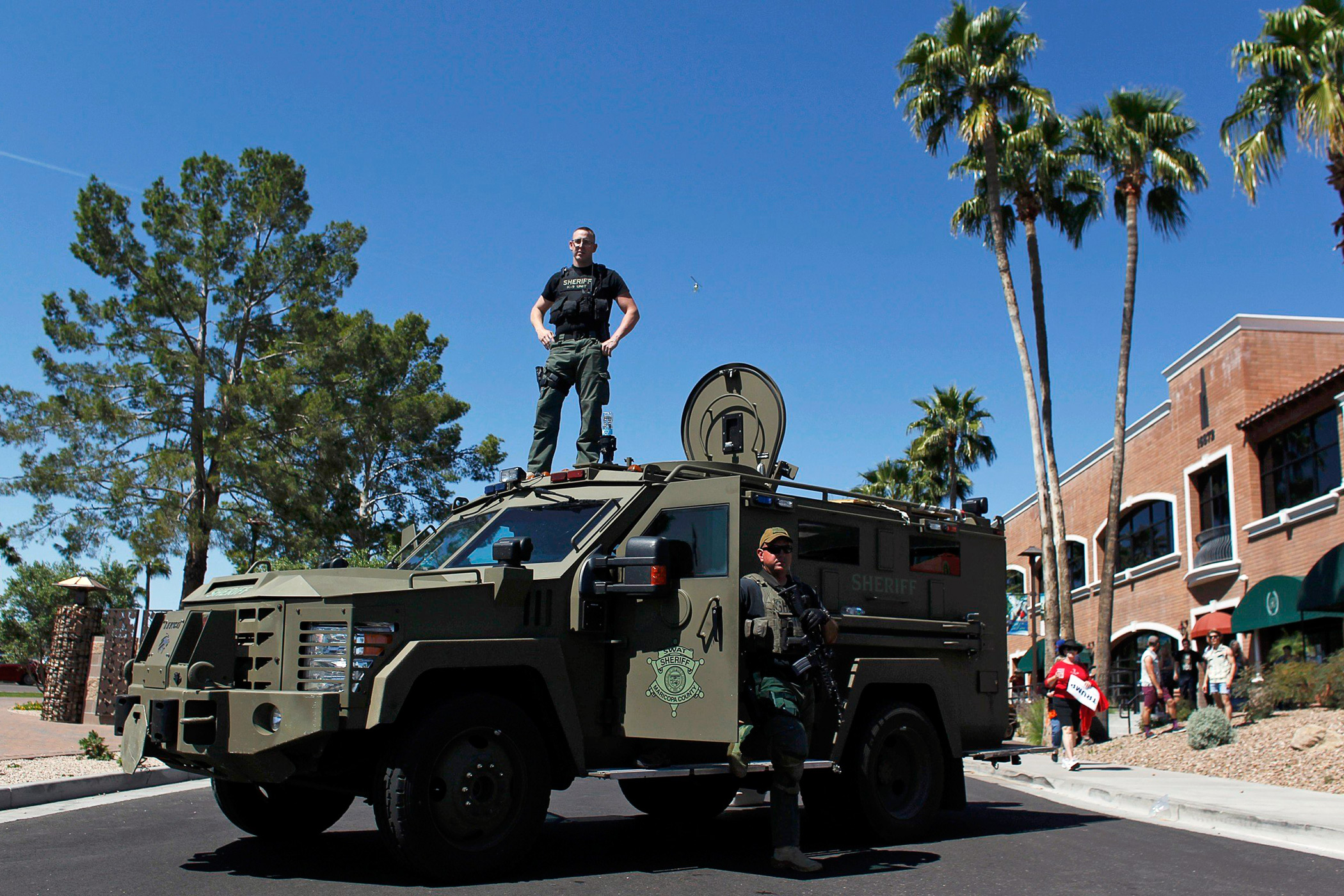 Maricopa County, Arizona police SWAT team stand guard with an armored vehicle outside a campaign rally for Republican presidential candidate Donald Trump in Fountain Hills, Ariz. on March 19.