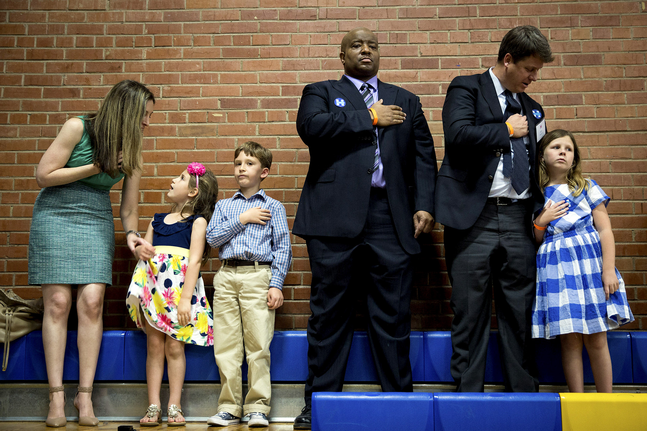 Members of the audience recite the Pledge of Allegiance before Hillary Clinton speaks in Phoenix, Ariz., on March 21.