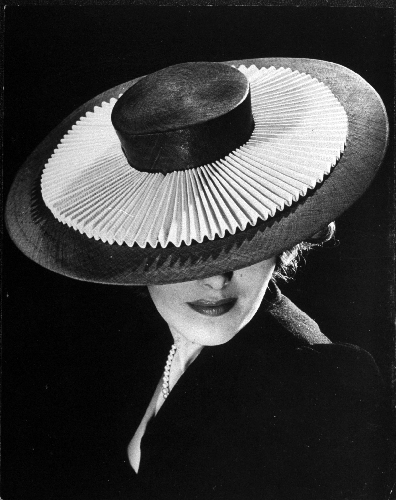 A woman modeling a Sally Victor Hat. 1940.