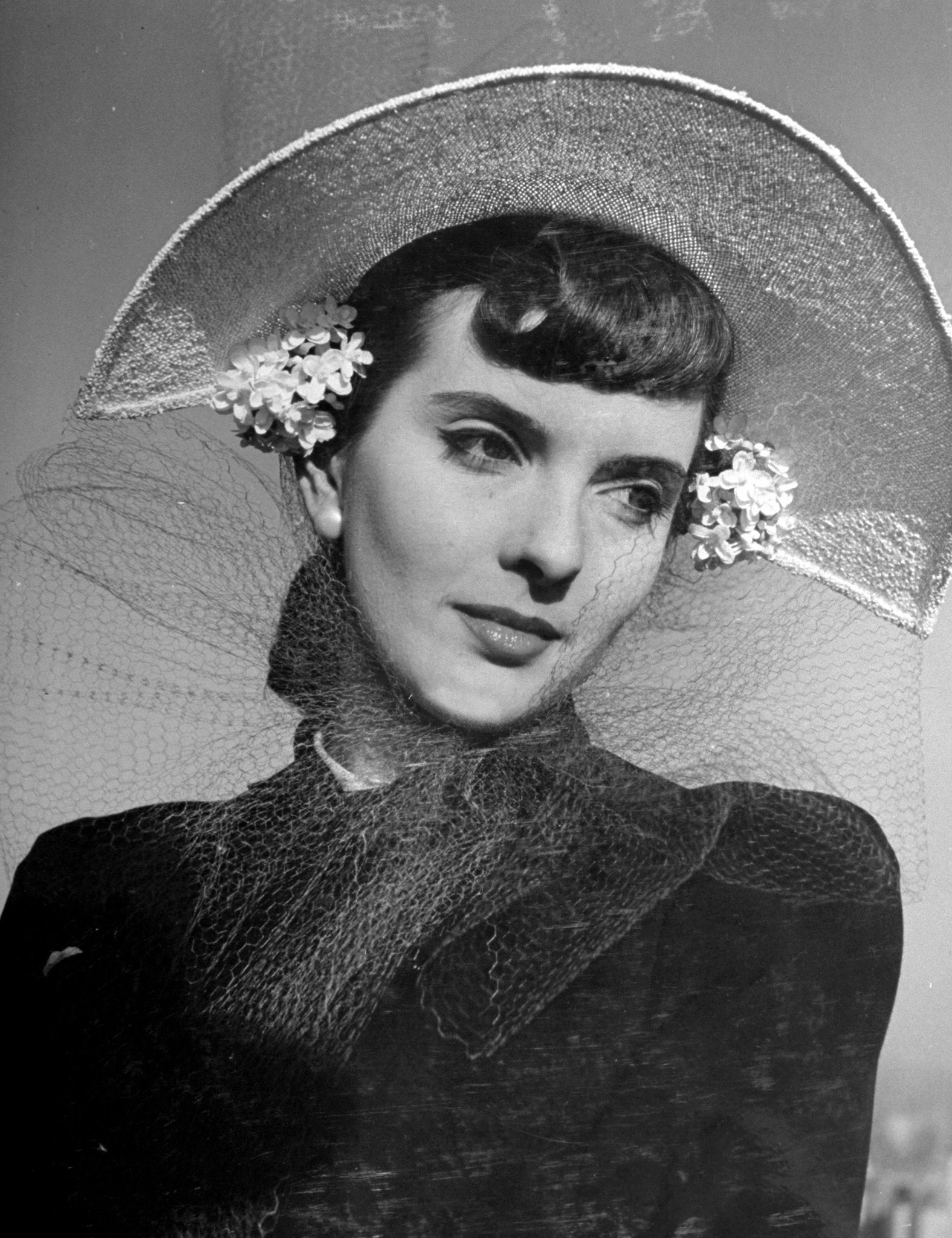 A woman modelling a new spring hat. 1941.