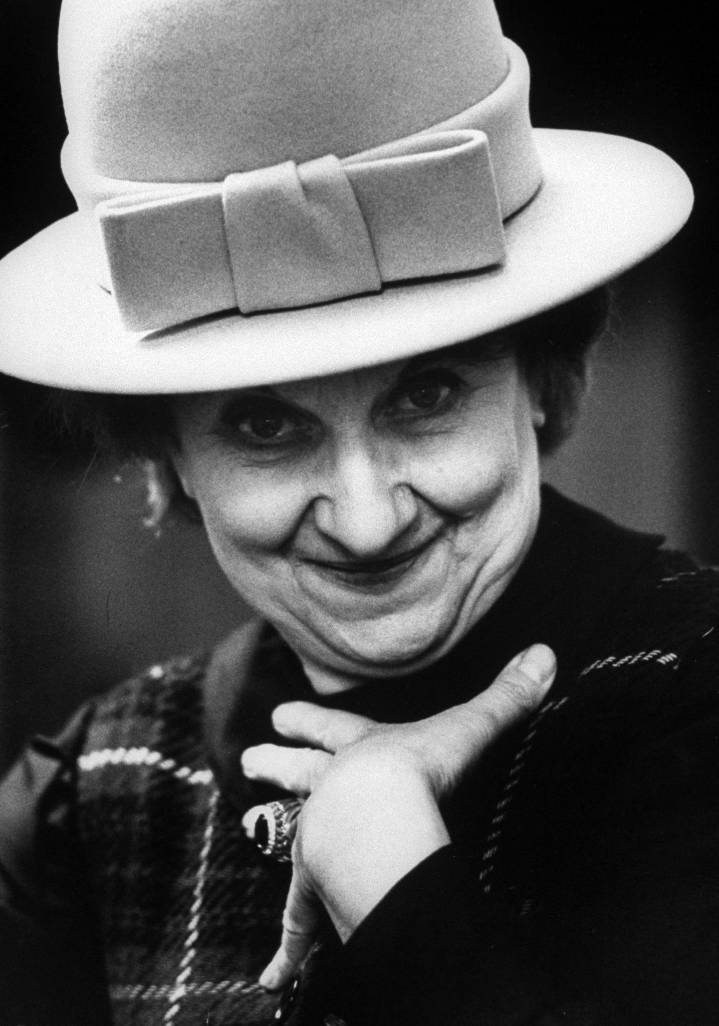 English comedienne Hermione Gingold modeling a derby-style hat. 1963.