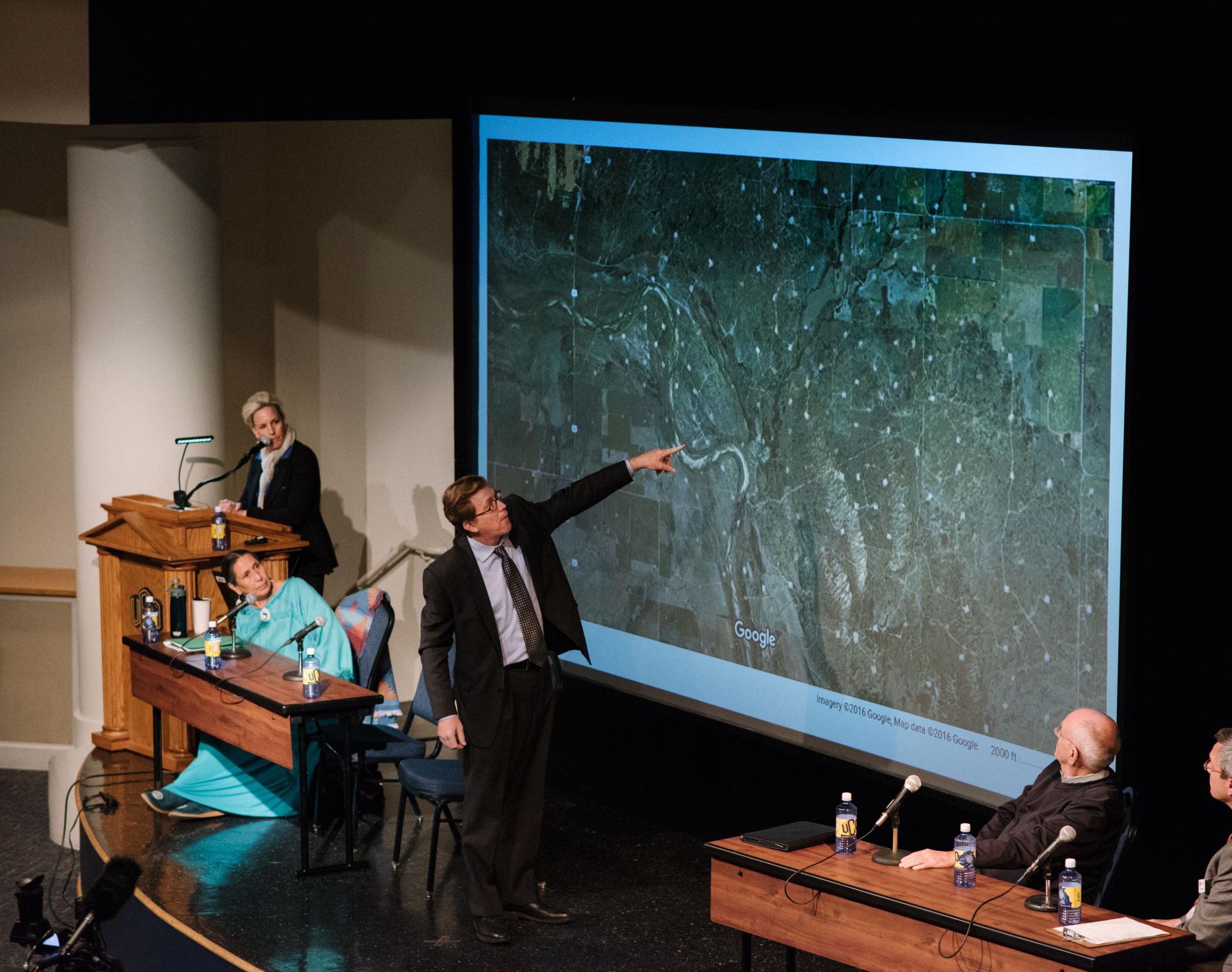 Johnson Bridgewater from the Sierra Club, points to areas affected by earthquakes at a public forum event hosted by Erin Brockovich and attended by notable public figures such as Casey Camp-Horinek from the Ponca Nation. Edmond, OK