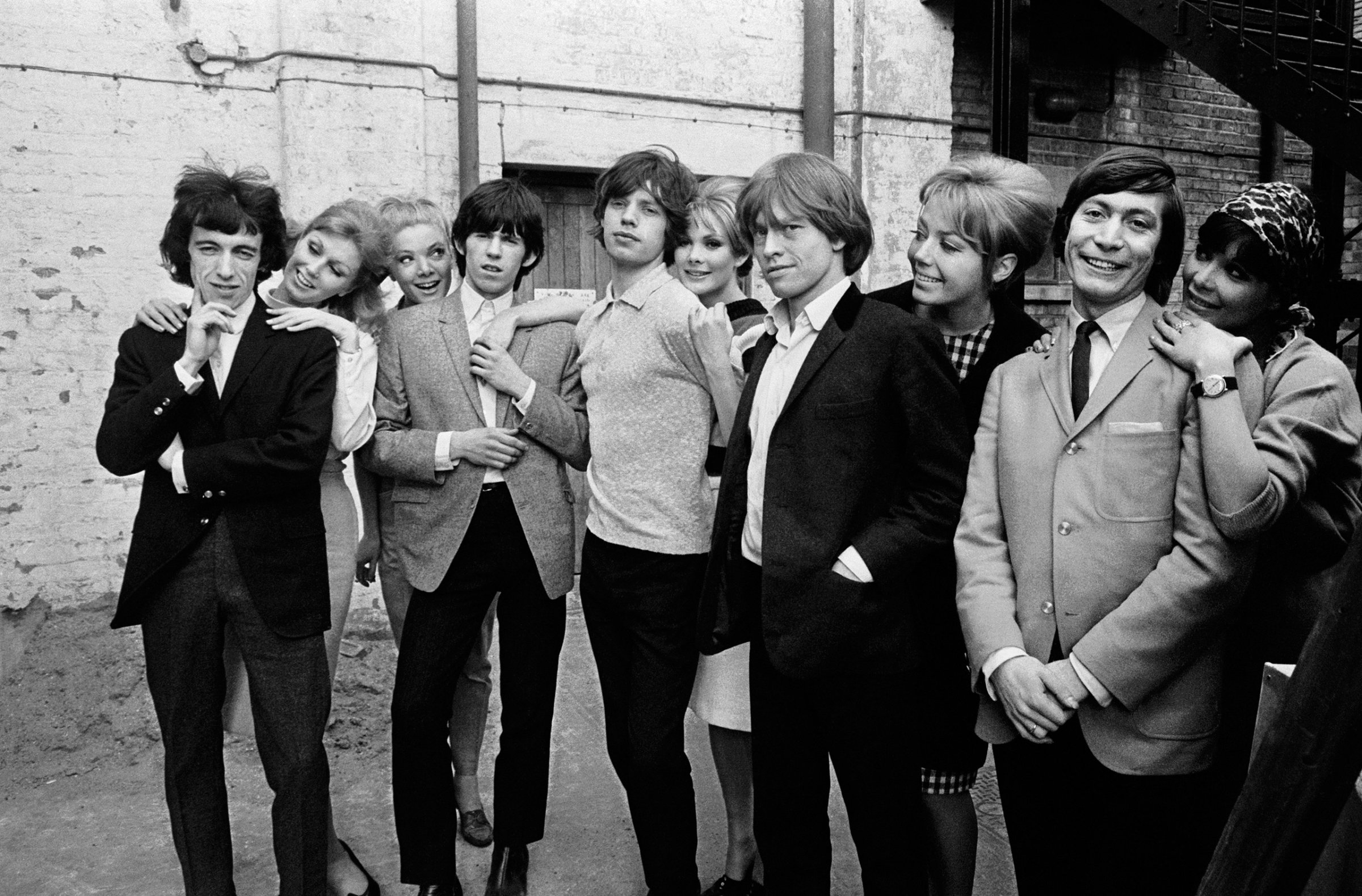 The Rolling Stones posing with a group of women during rehearsals for ABC's 'Thank Your Lucky Stars' TV pop music show at Teddington Studios, London, November 11, 1964. From left to right, Bill Wyman, Keith Richards, Mick Jagger, Brian Jones and Charlie Watts.
