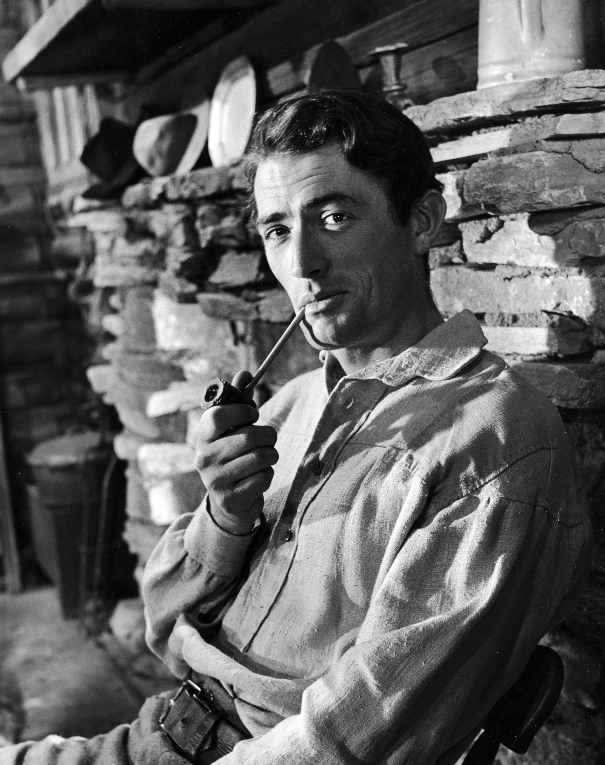 Gregory Peck smoking a pipe for a scene in the movie "The Yearling." 1947.