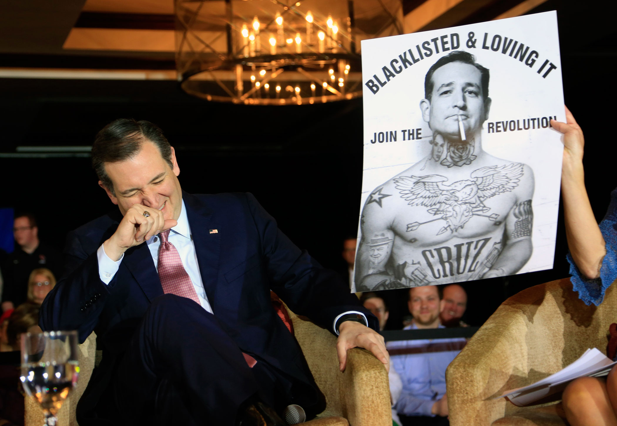 Republican presidential candidate, Texas Sen. Ted Cruz laughs at a poster in his likeness at a town hall event on March 30, 2016 in Madison, Wis.