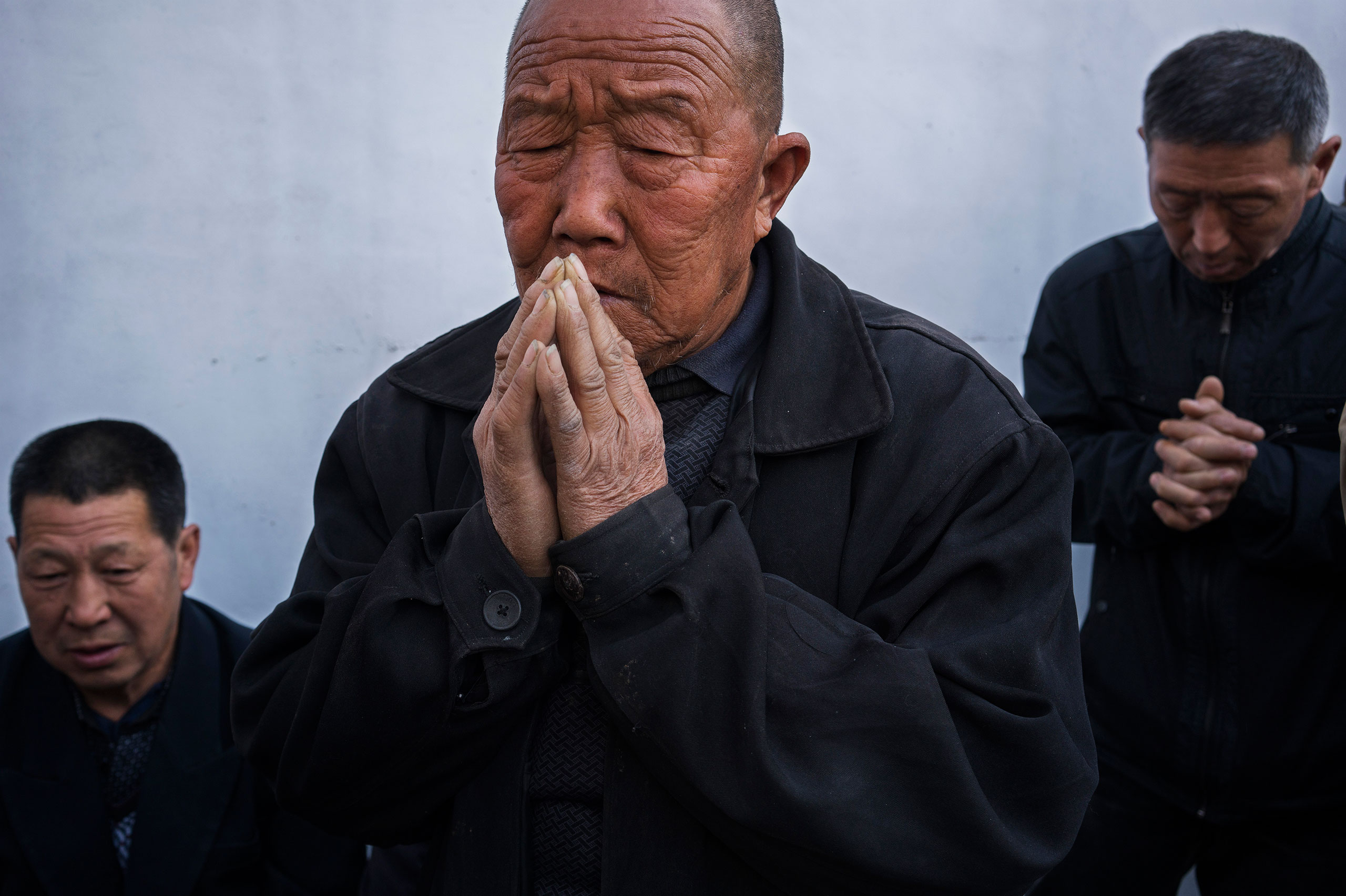 Villagers pray at an underground Easter Sunday Mass led by dissident Catholic Priest Dong Baolu in the yard of his house in Youtong village, Shijiazhuang, China, March 27, 2016.