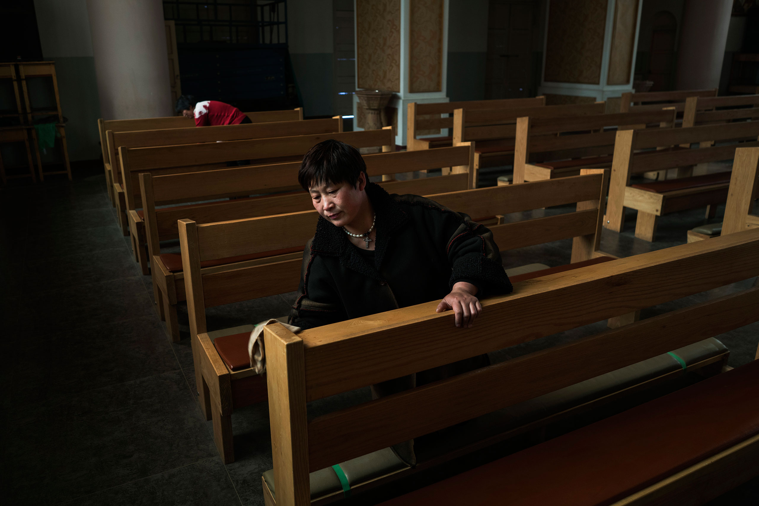 A volunteer cleans a pew ahead of a Mass at the government sanctioned Catholic Church of Virgin Mary in Donglu, near Baoding, China, March 20, 2016. Hebei has one of the largest populations of Christians in China who practice at both legal and underground Churches.