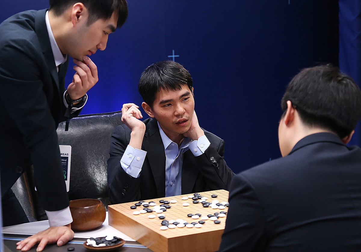 In this handout image provided by Google, South Korean professional Go player Lee Se-Dol reviews the match with other professional Go players after the fourth match against Google's artificial intelligence program, AlphaGo, during the Google DeepMind Challenge Match in Seoul, South Koreaon March 13, 2016.