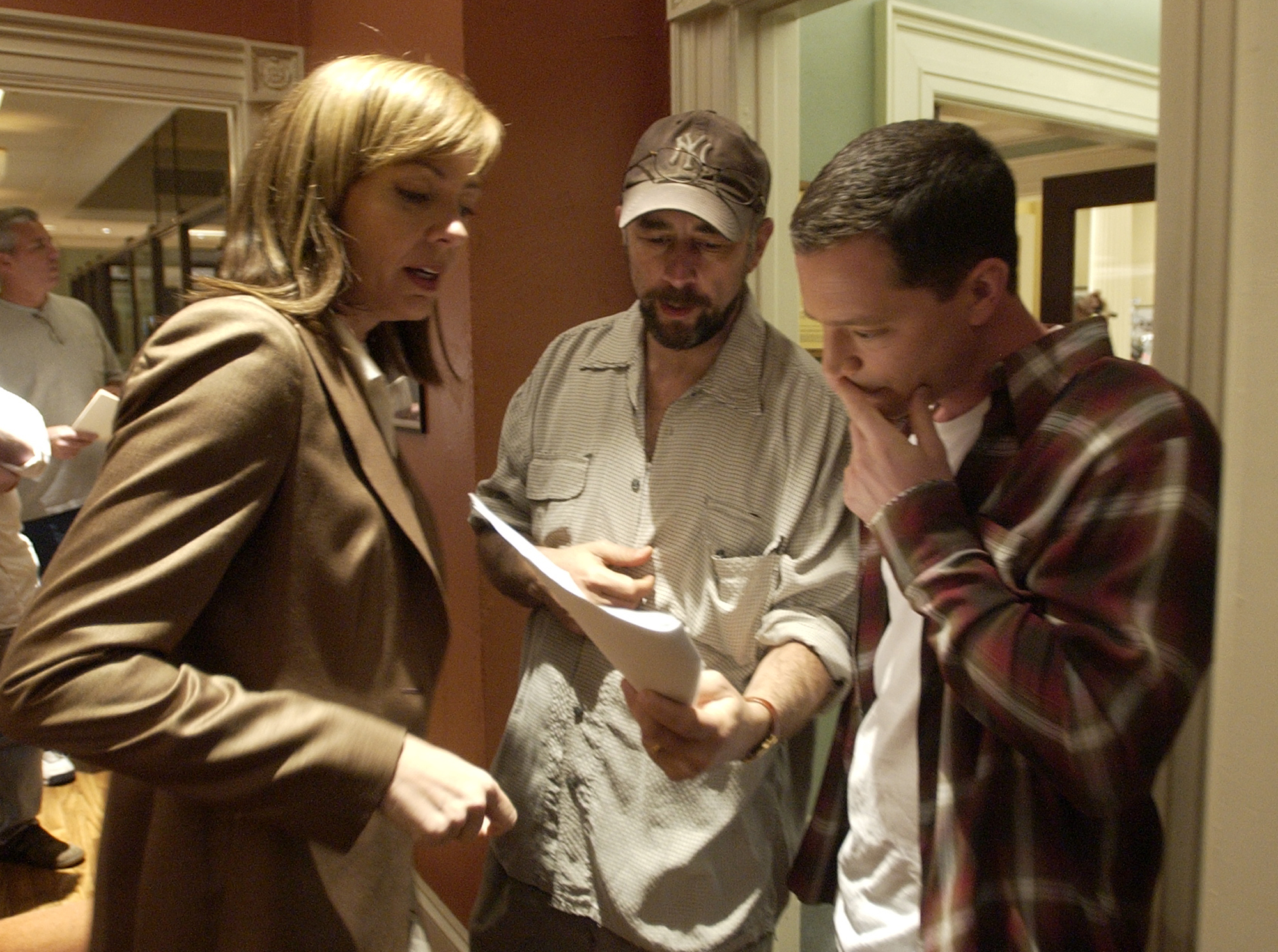 Actors Josh Malina, right, who plays White House aide Will Bailey on NBC's  "The West Wing," goes over a scene with cast members Allison Janney, and Richard Schiff during filming in Burbank, Calif., March 10, 2004. (Reed Saxon—AP)