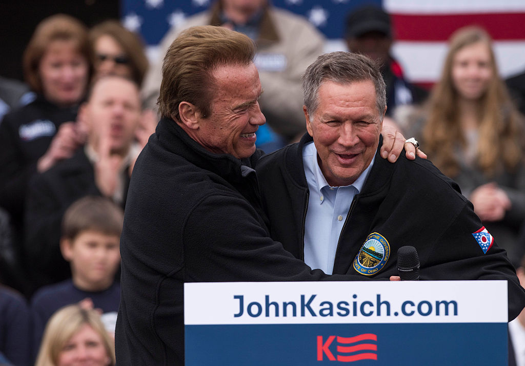 Ohio Gov. John Kasich is embraced by former California Governor Arnold Schwarzenegger before taking to the podium during a campaign rally at the Wells Barns at the Franklin Park Conservatory on March 6, 2016 in Columbus, Ohio.