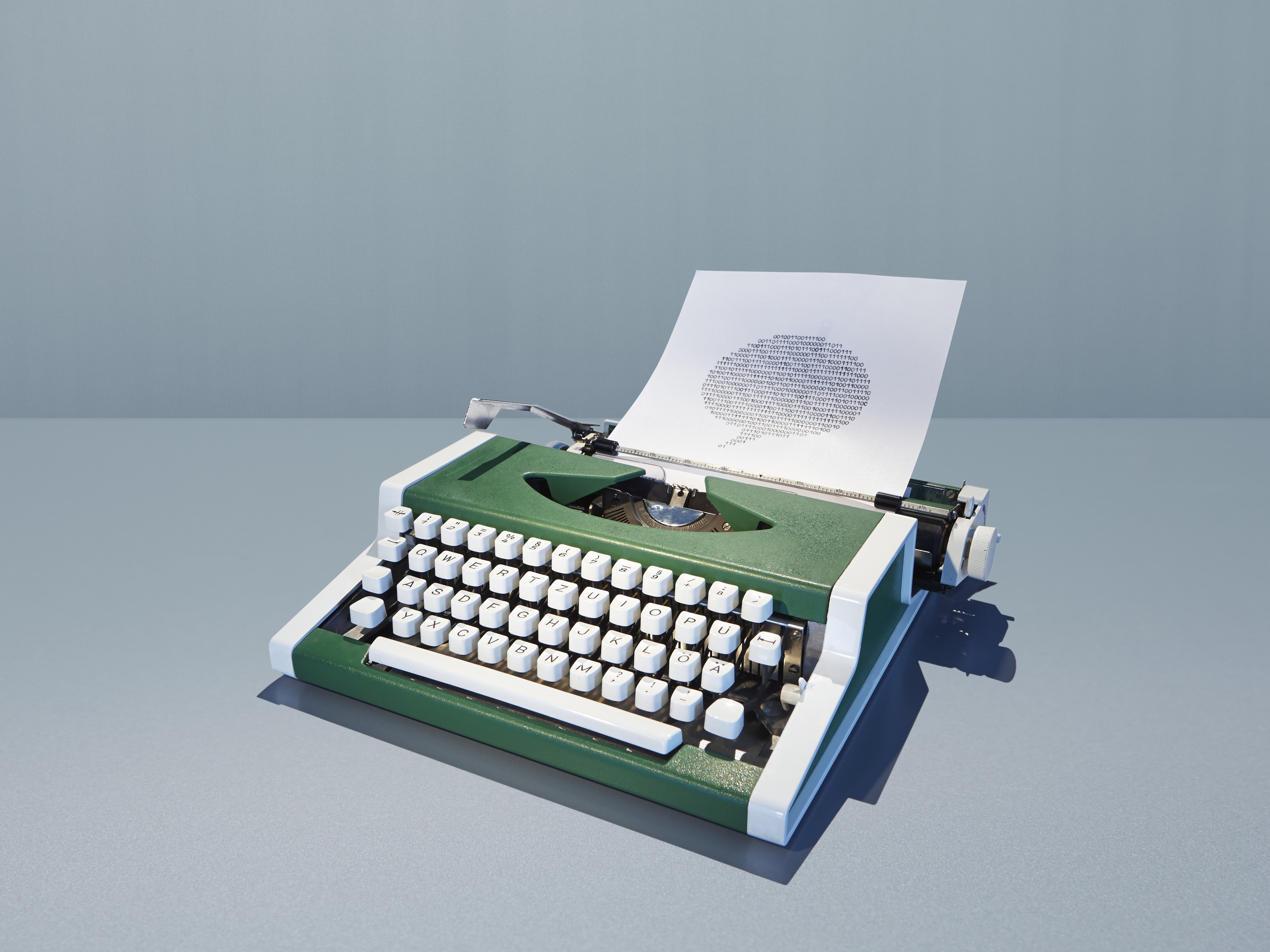 Typewriter with bubble of binary digits (Getty Images)