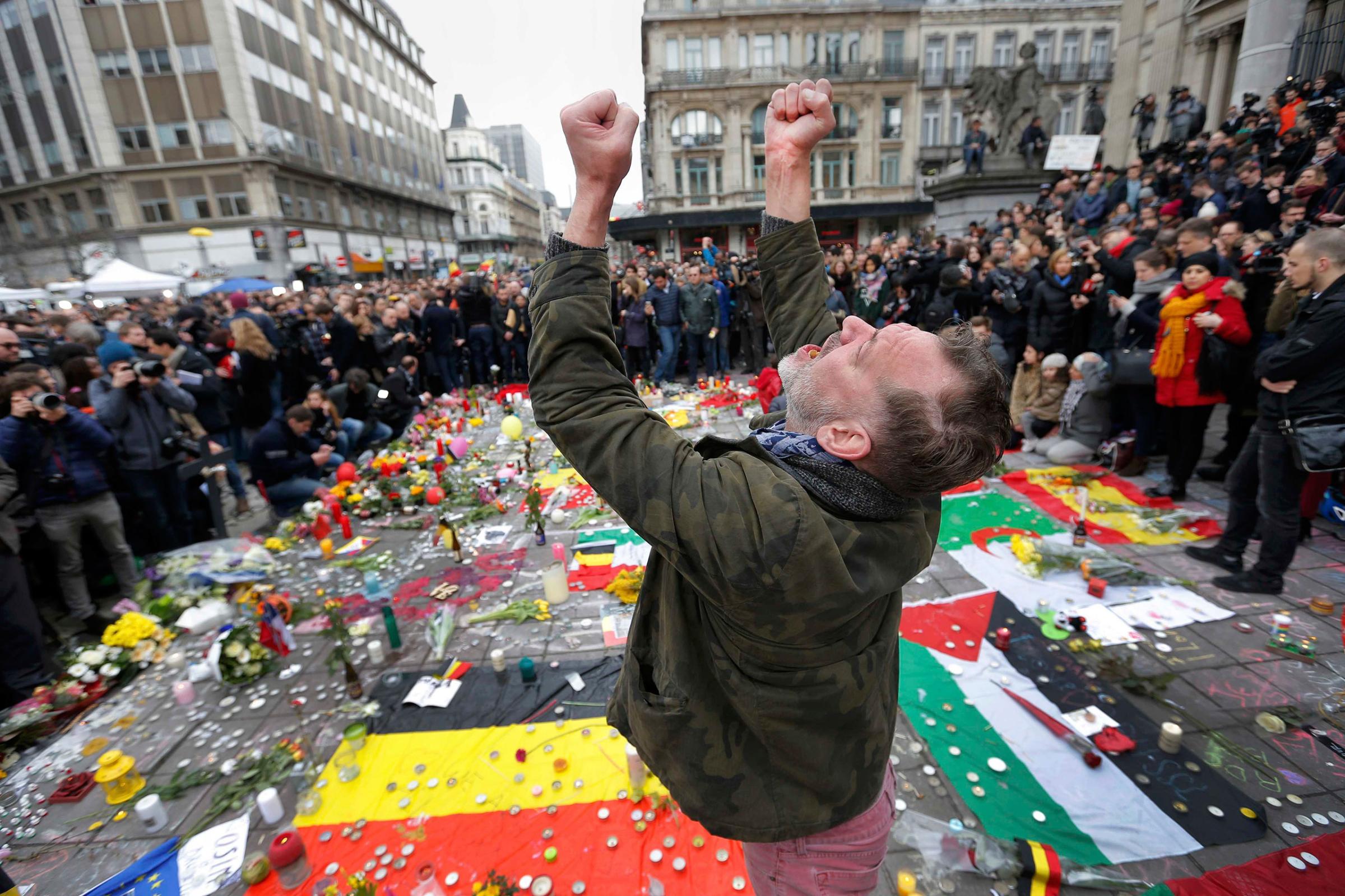 A man reacts at a street memorial following Tuesday's bomb attacks in Brussels, Belgium, March 23, 2016.